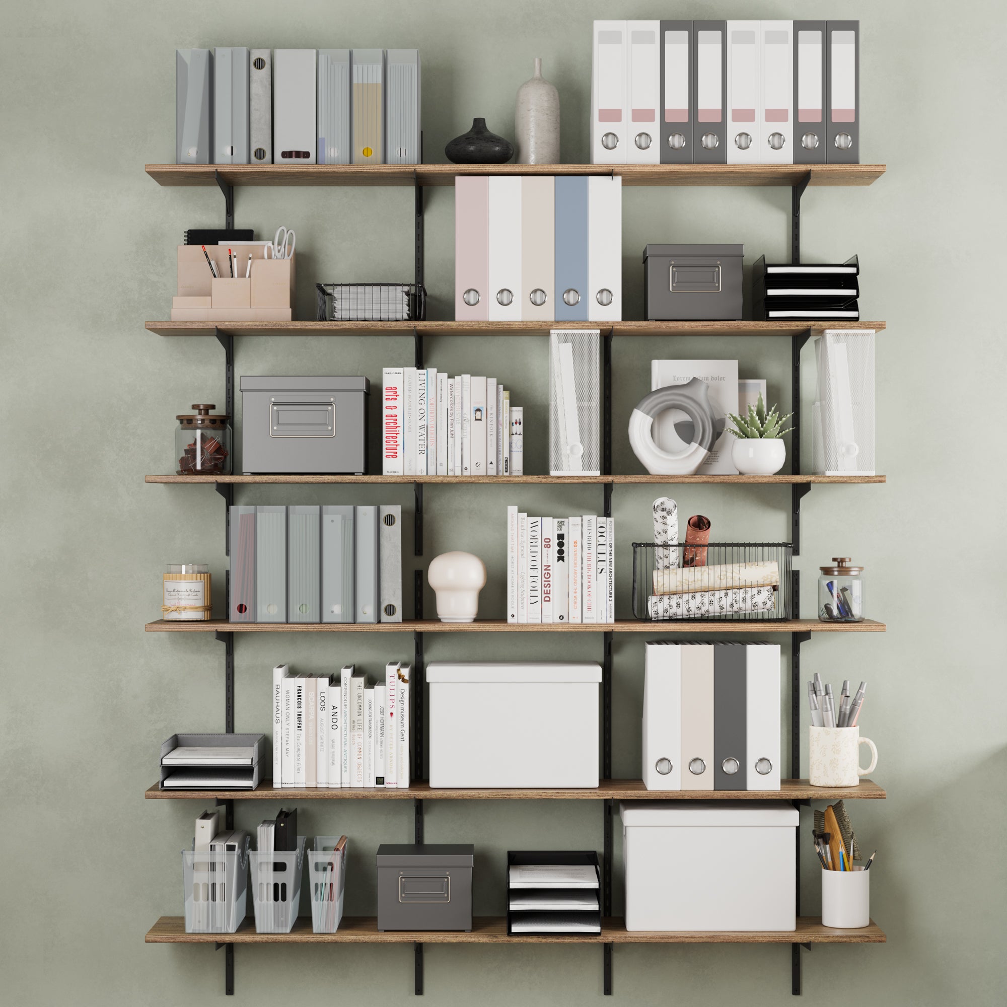 A stylish wall mounted bookshelf displays a mix of books, decorative objects like a circular sculpture, a gold figure, and framed artwork. A comfortable green chair and potted plant add life to the space.