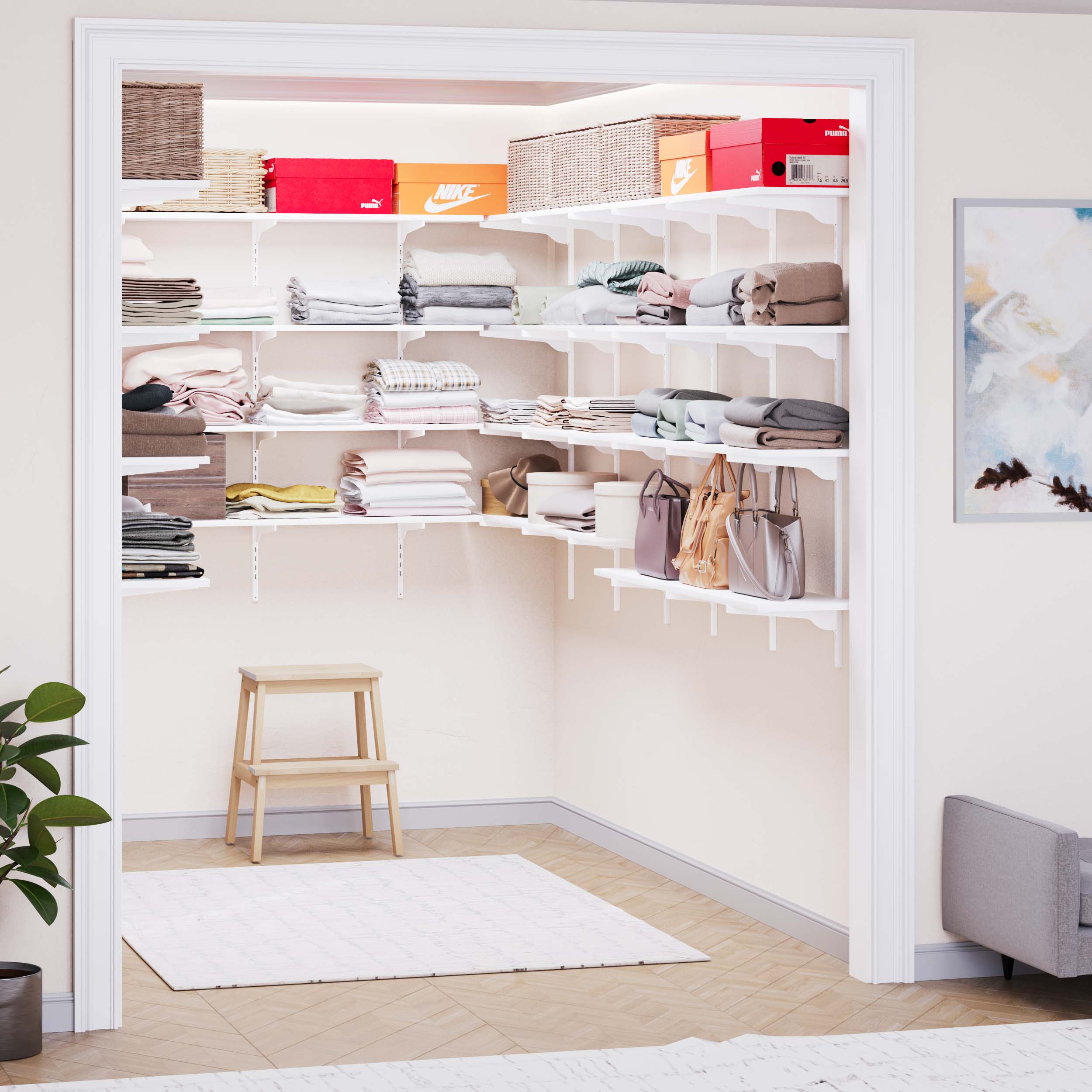 An open closet with neatly arranged adjustable shelves containing towels, baskets, and clothing.