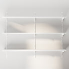 A fully assembled, empty 3-tier wall-mounted storage shelving system, ready to be styled with books or decor.