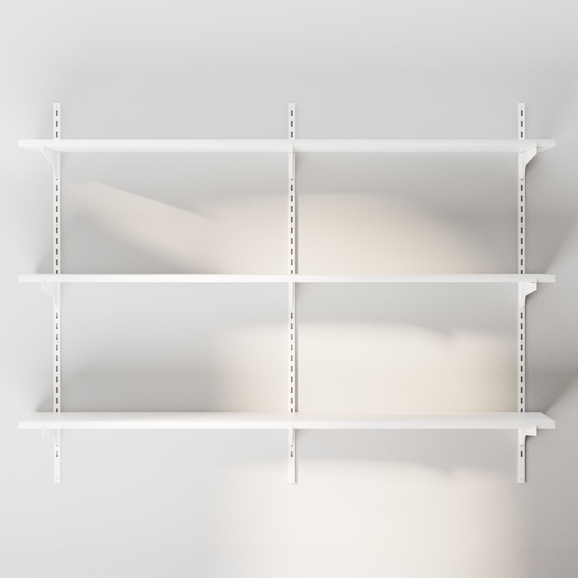 A fully assembled, empty 3-tier wall-mounted storage shelving system, ready to be styled with books or decor.