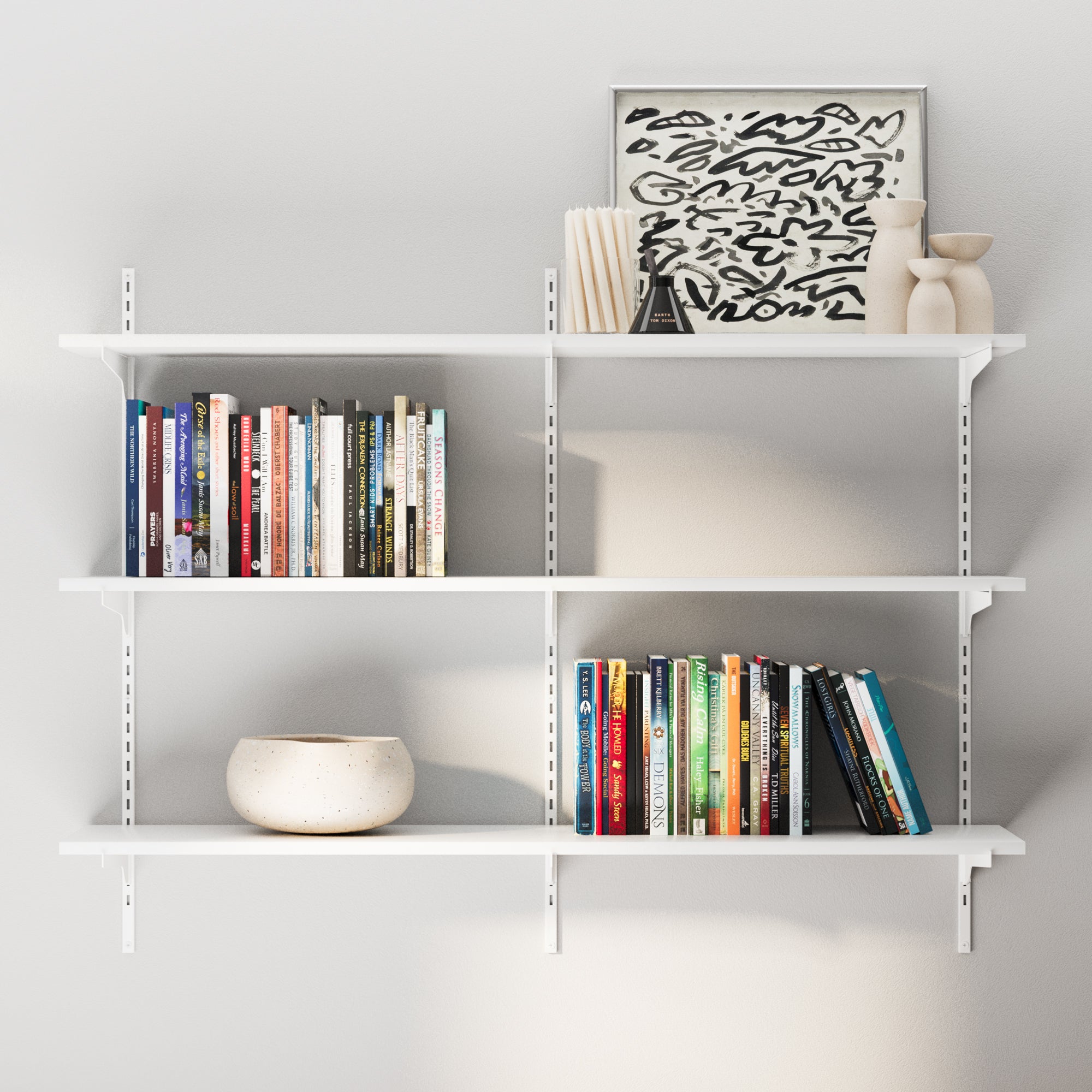 A modern white 3-tier wall bookshelf mounted on adjustable metal tracks, styled with books and decor for a clean and organized wall setup.