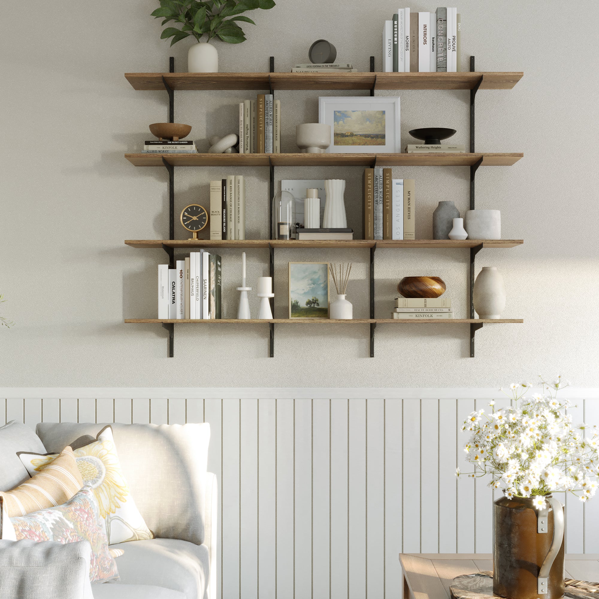 A 4-tier 60 inch long wooden storage shelf is used for soft-toned books, candles, vases, and framed art, blending into a cozy, neutral-toned living room setup.