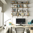 Positioned above a workspace, solid wood shelving system in a farmhouse burnt finish provides efficient vertical storage for books, office supplies, and personal items.