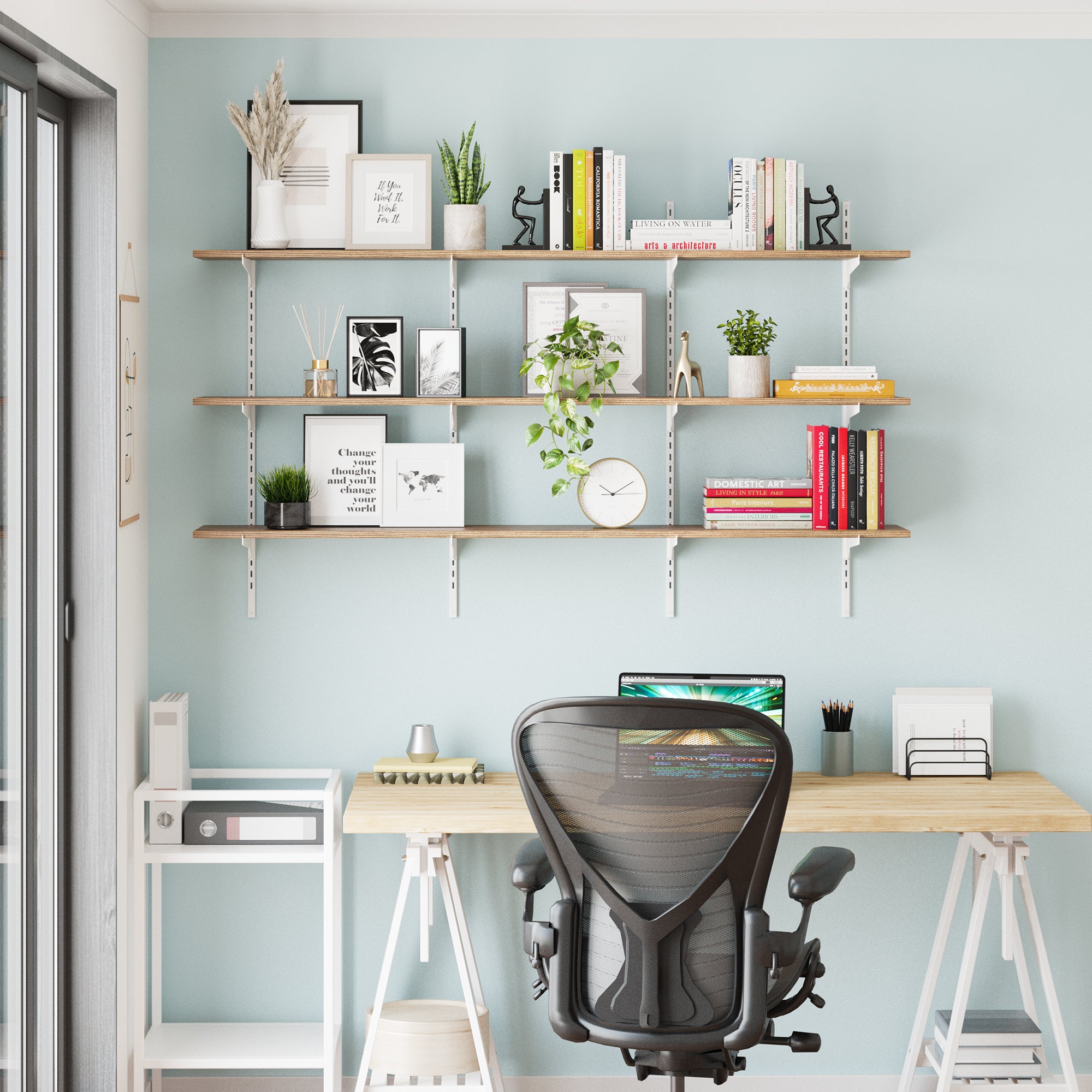 A minimalist workspace setup showing the shelf as a home office wall organizer. Perfect for books, décor, and plants above a desk—ideal for creating an inspiring and organized work area.