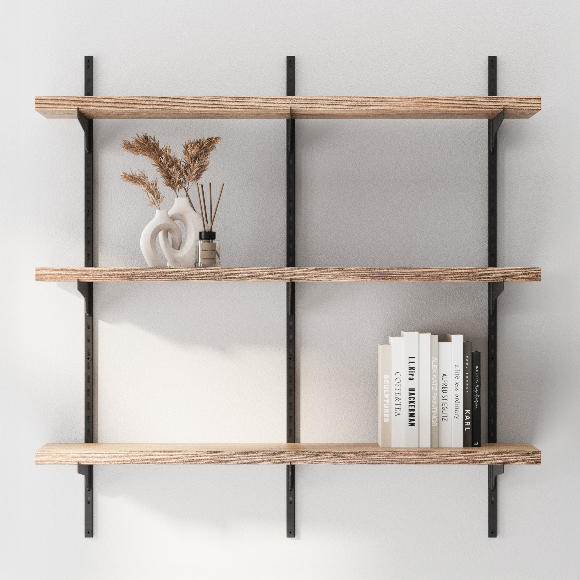 3 Tier boho shelves with books and decorative items against a white wall