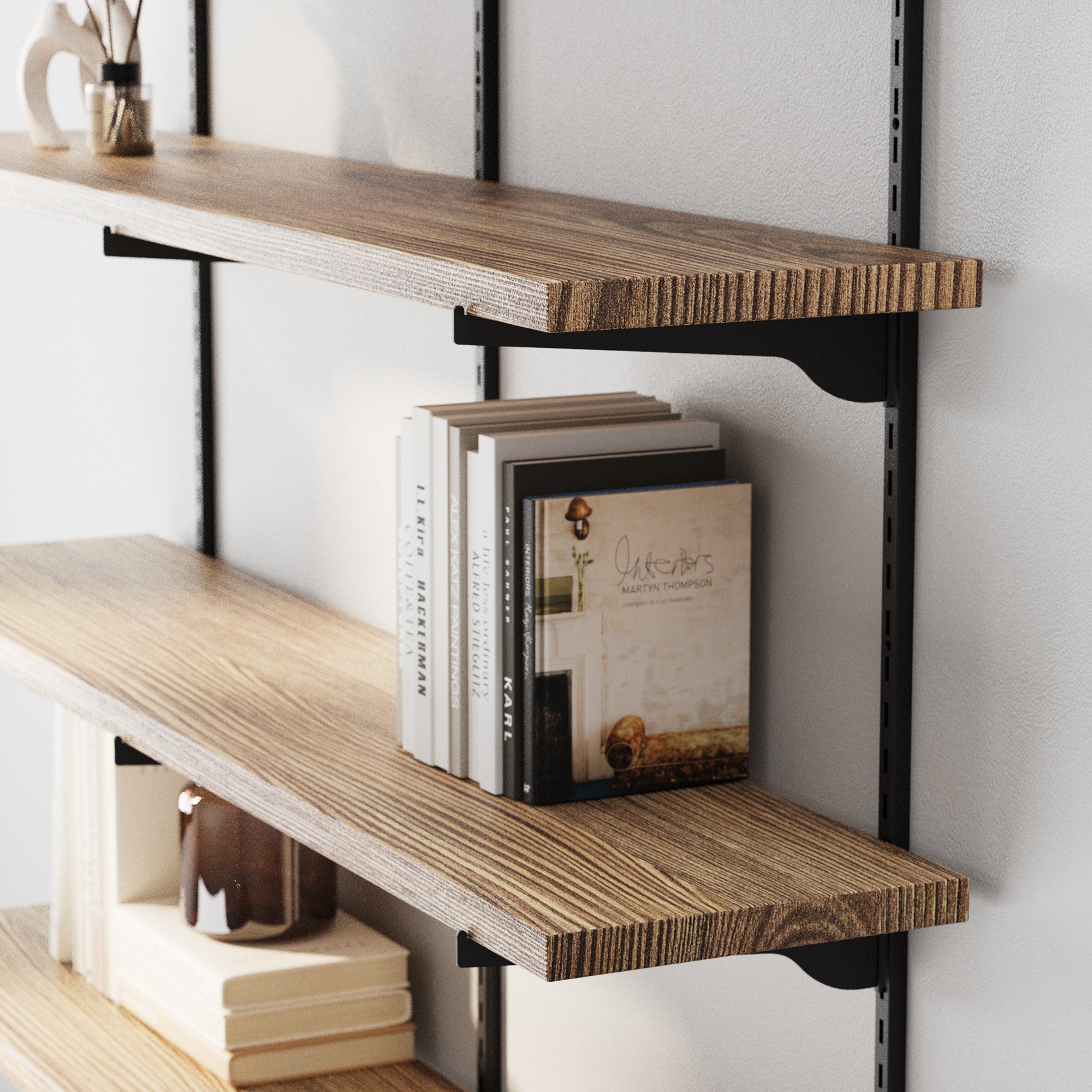 Real wood shelves with books and decorative items against a white wall