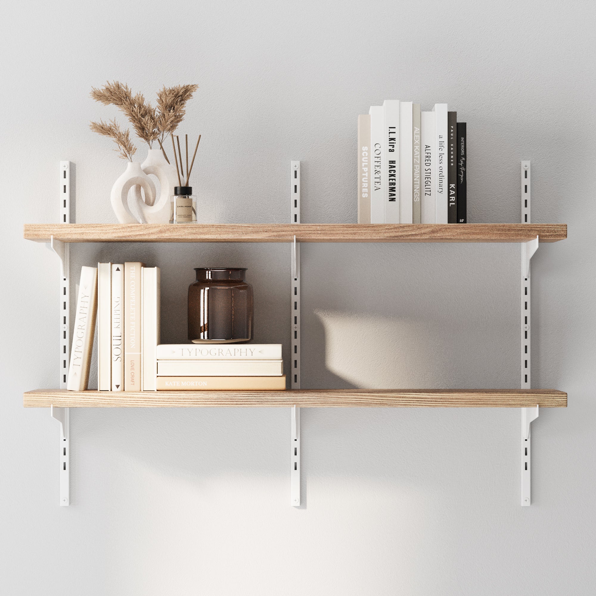 2 tier decorative shelves with books and decorative items against a light gray wall