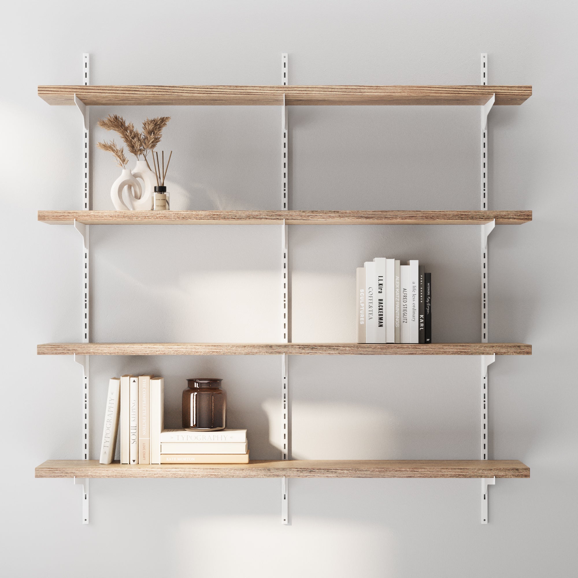 Storage shelves for living room decor with books and decor items against a light gray wall