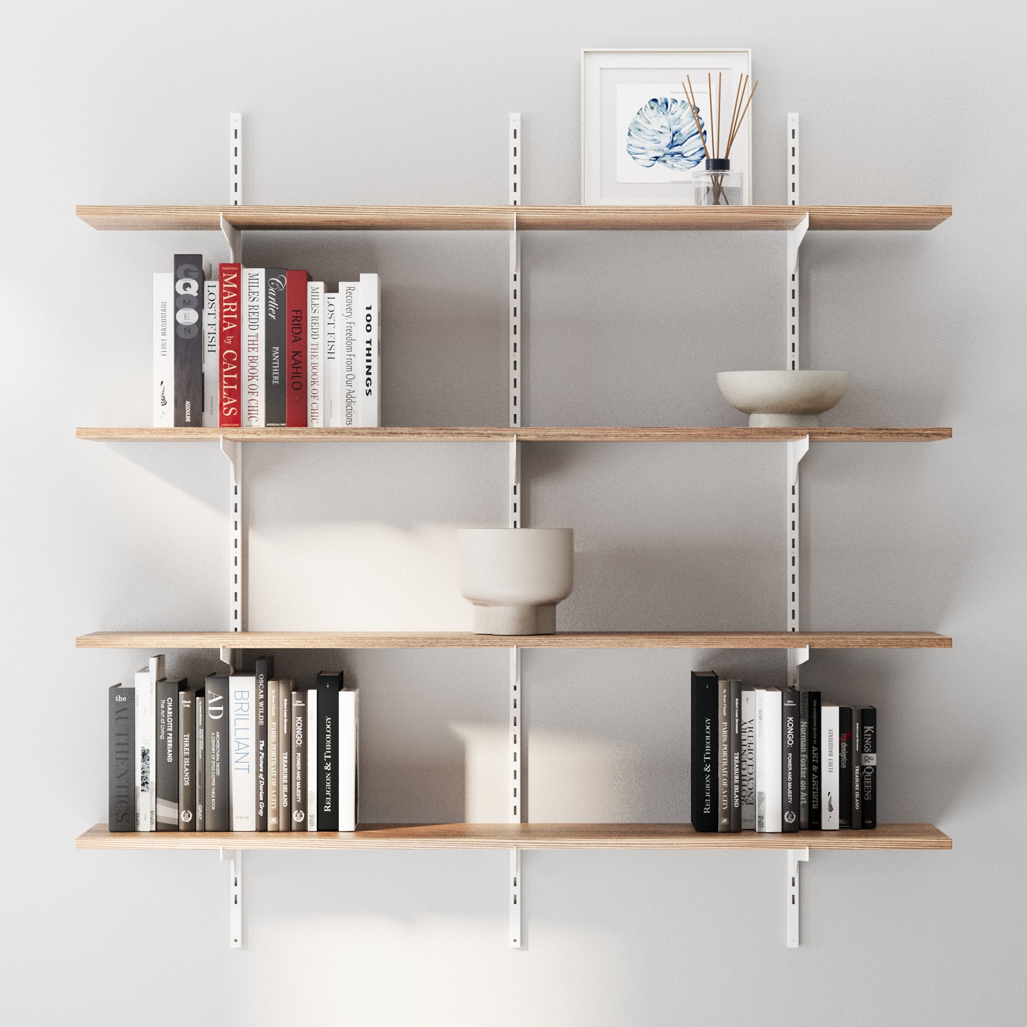 4 tiered boho shelves for wall decor with books and decorative items against a gray wall