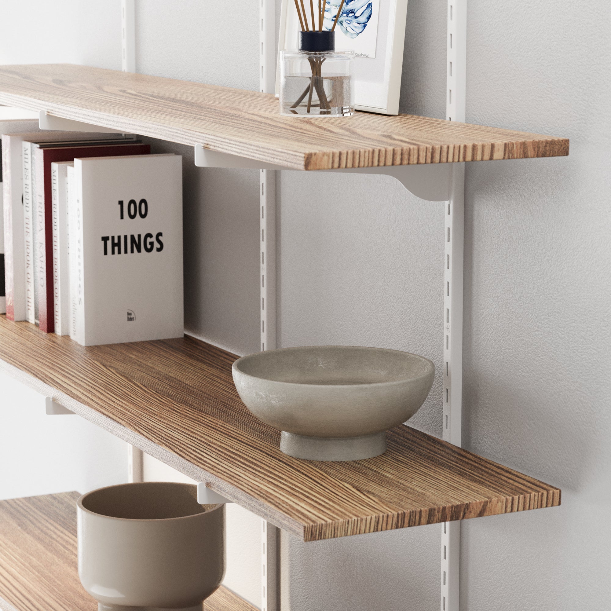 Paulownia wood shelving unit with white adjustable brackets holding decorative items against a white wall