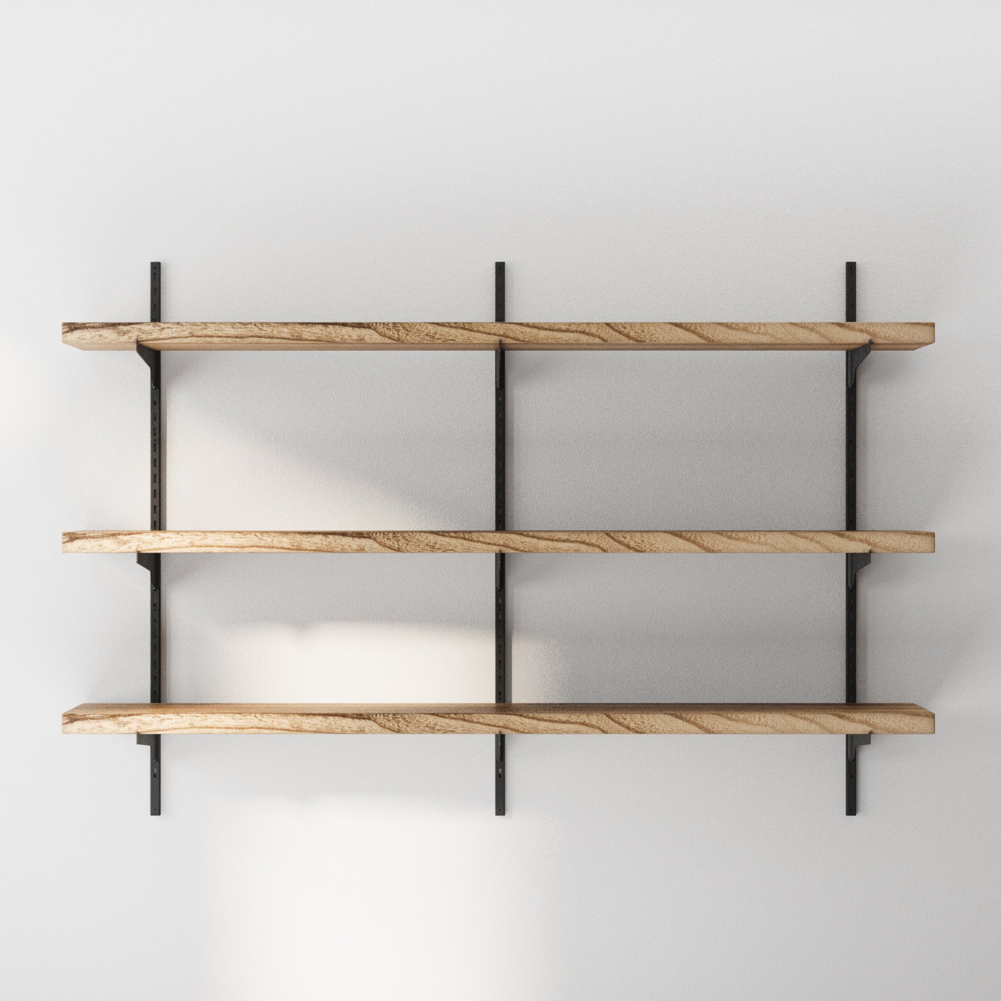 Wood storage shelves with black metal brackets on a white wall