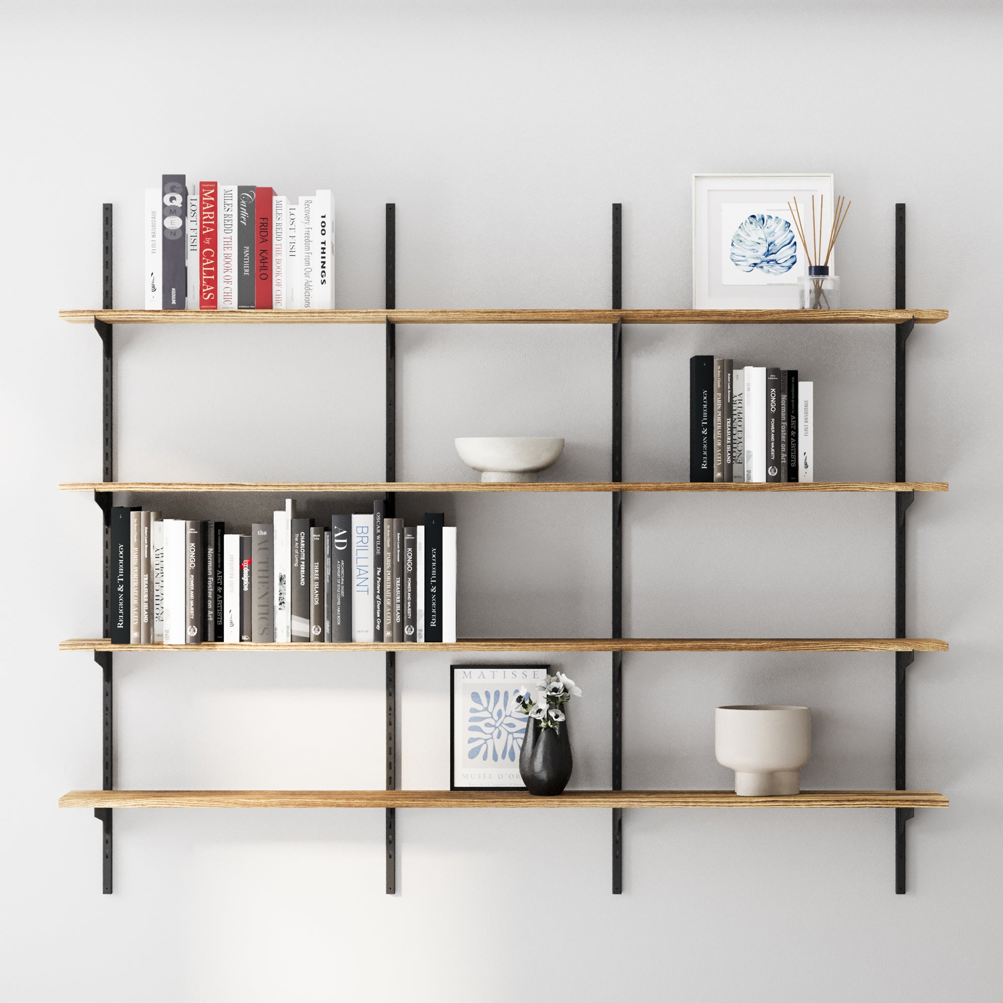 4 tier office shelves with books and decorative items against a gray wall