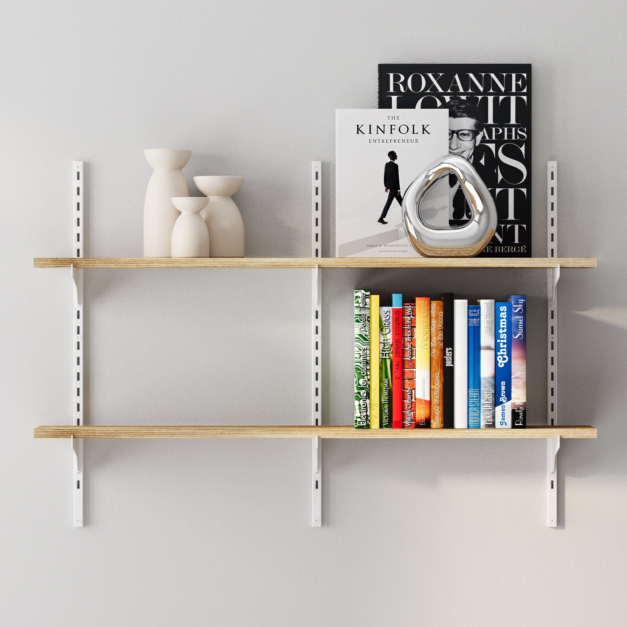 Wooden shelving unit with books and decorative items against a light gray wall