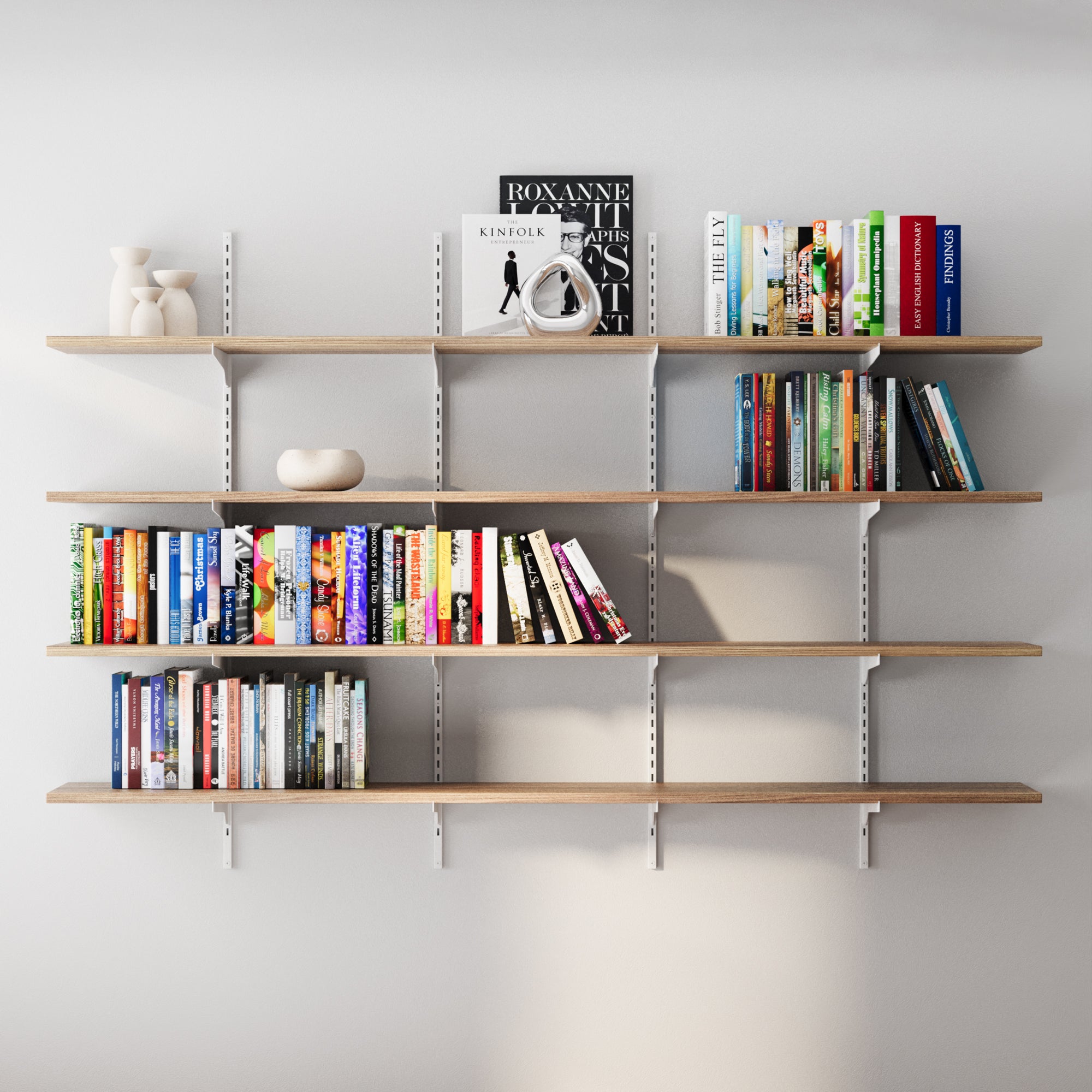 4 tier wall mounted shelving unit with books and decor against a white wall