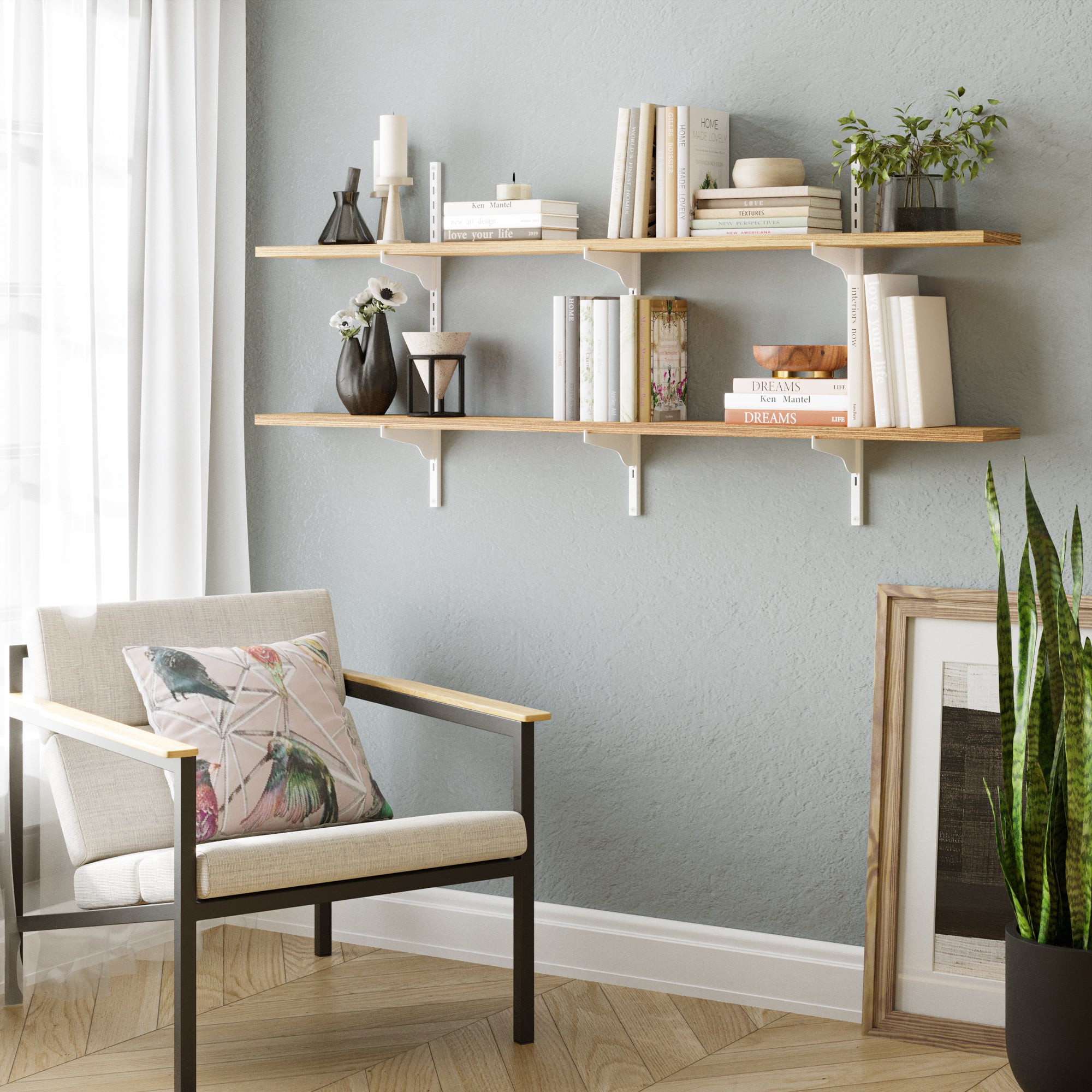 Bright living space featuring a two-tier adjustable wall shelf for living room decor with light wood boards and white brackets, styled with books, ceramics, and greenery above a cozy chair.