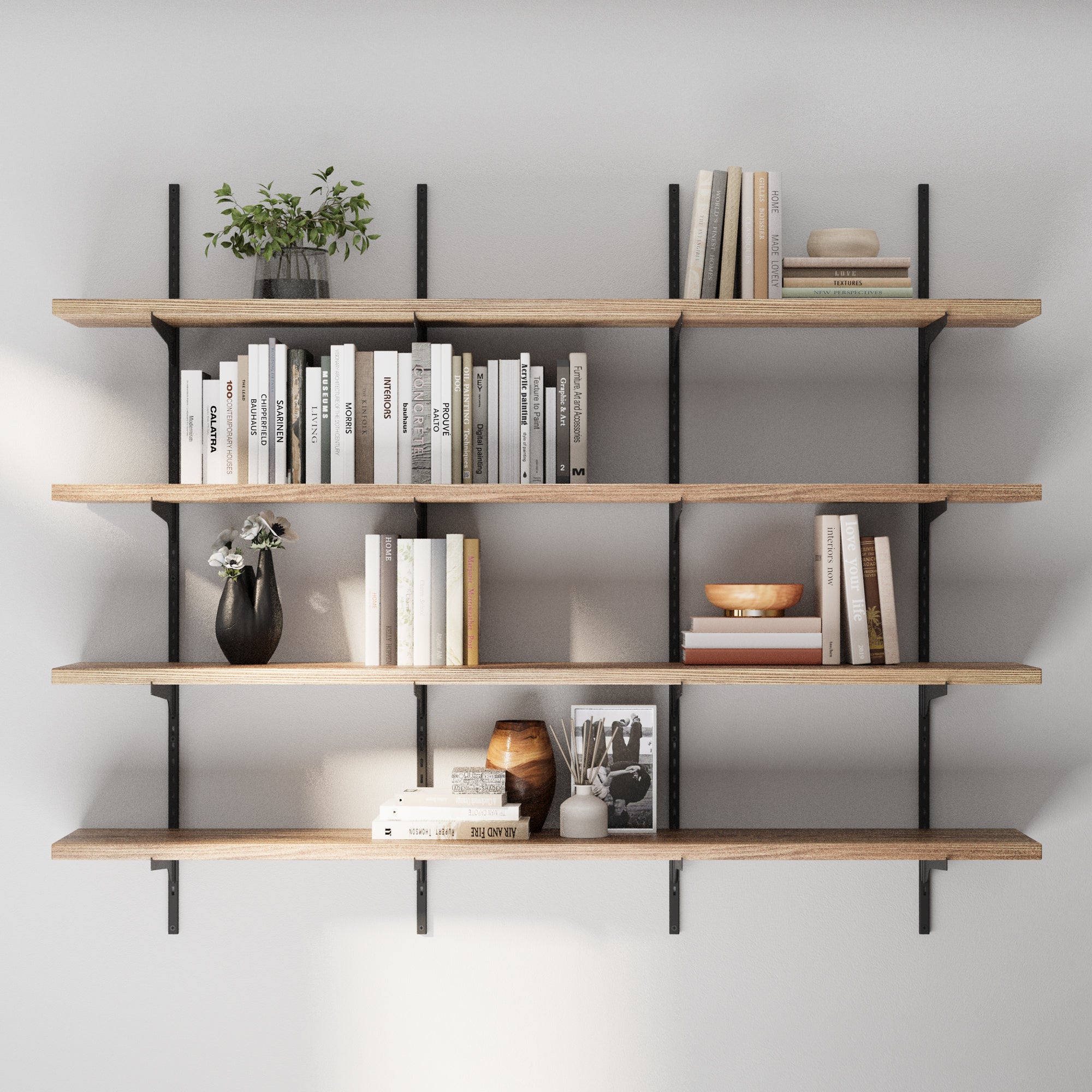 4 tiered adjustable shelving unit with books, plants, and decorative items against a gray wall.