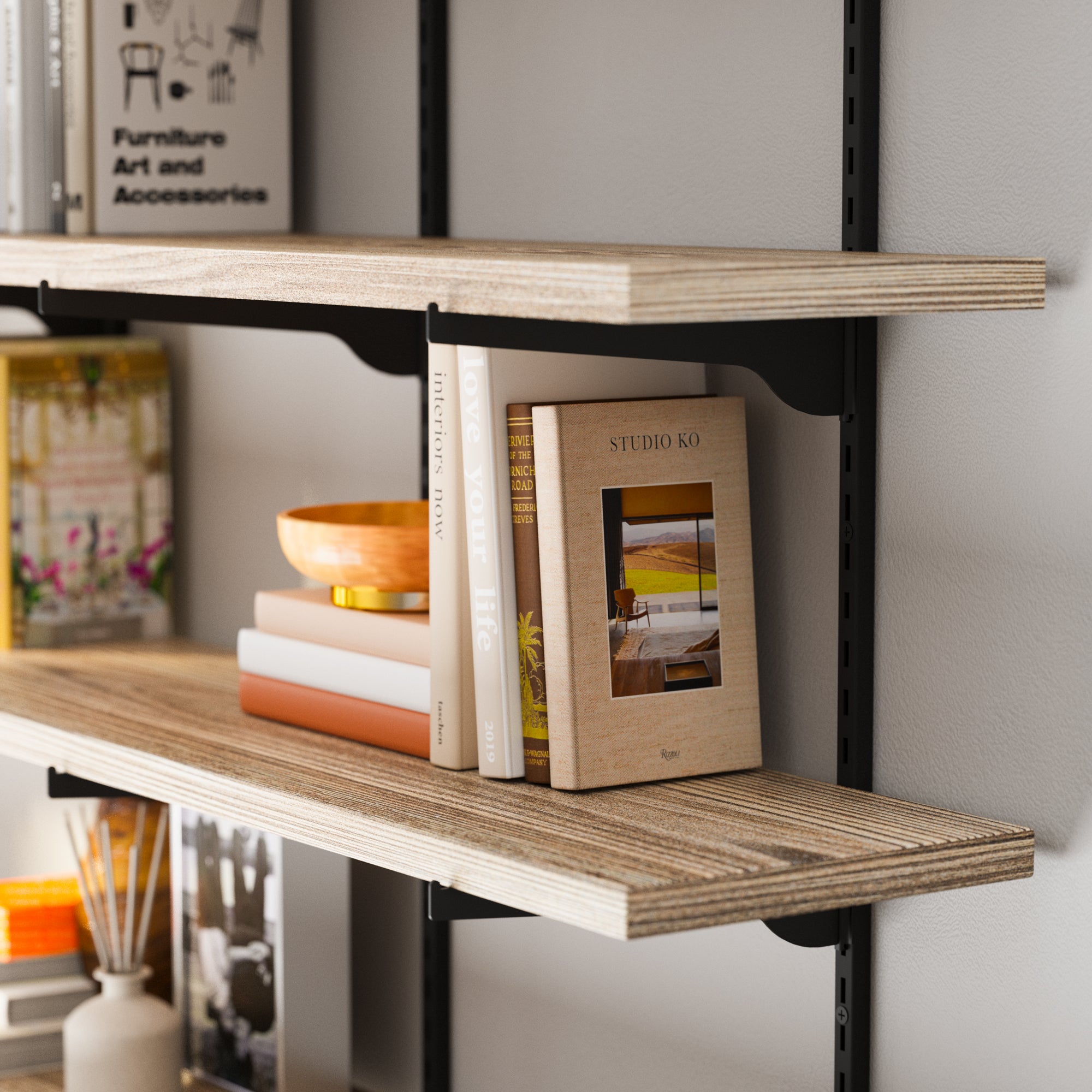 Decorative shelves with books and decor items against a neutral wall