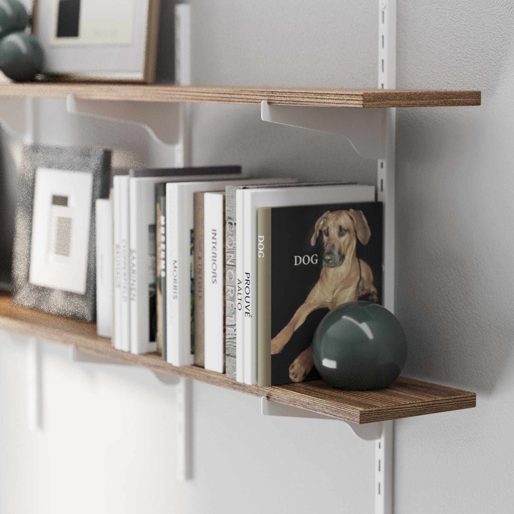 Adjustable rustic shelf with heavy duty white metal brackets and rails with books and a framed picture on a white wall