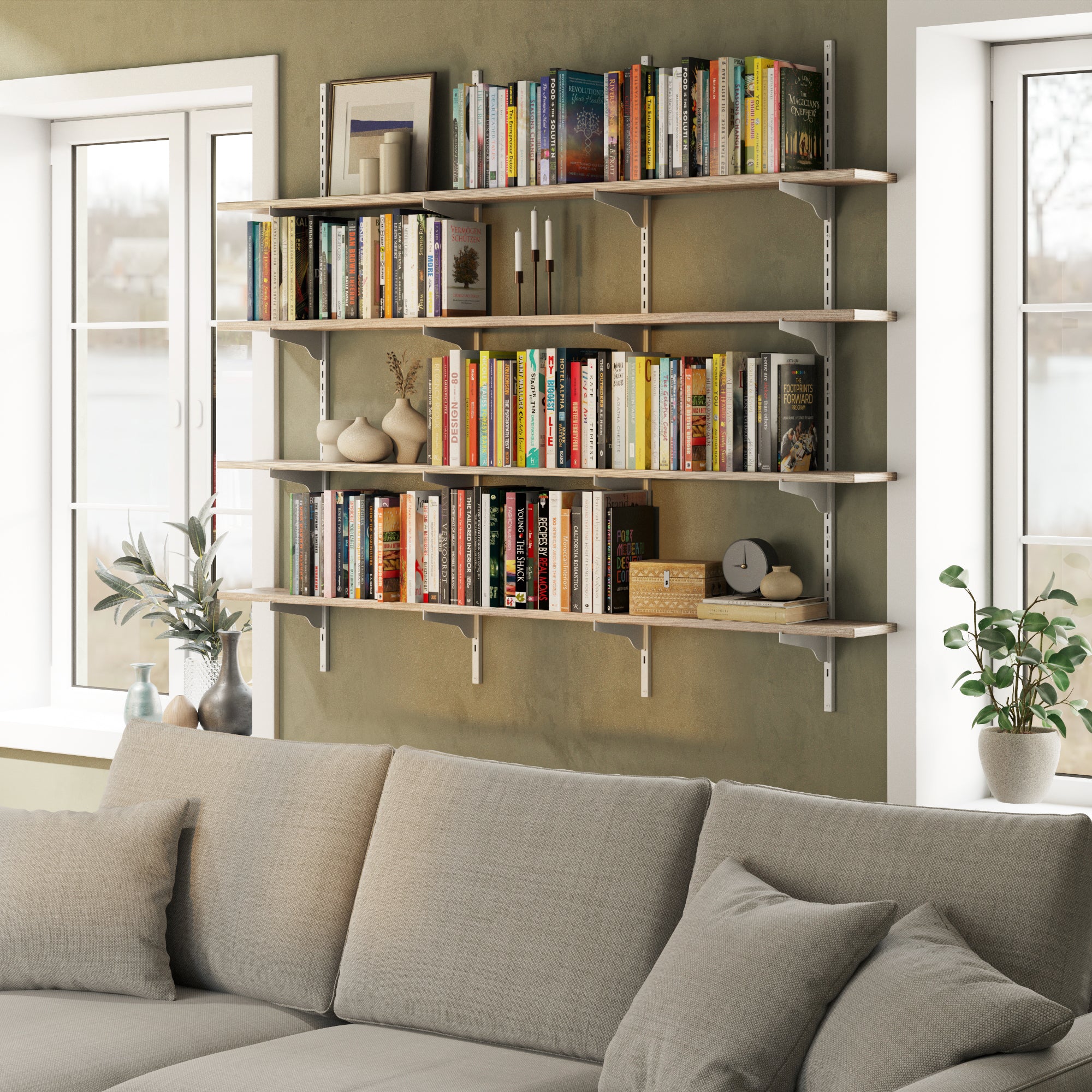 Rustic shelving unit for living room decor with books and decor items above a gray sofa in a living room.