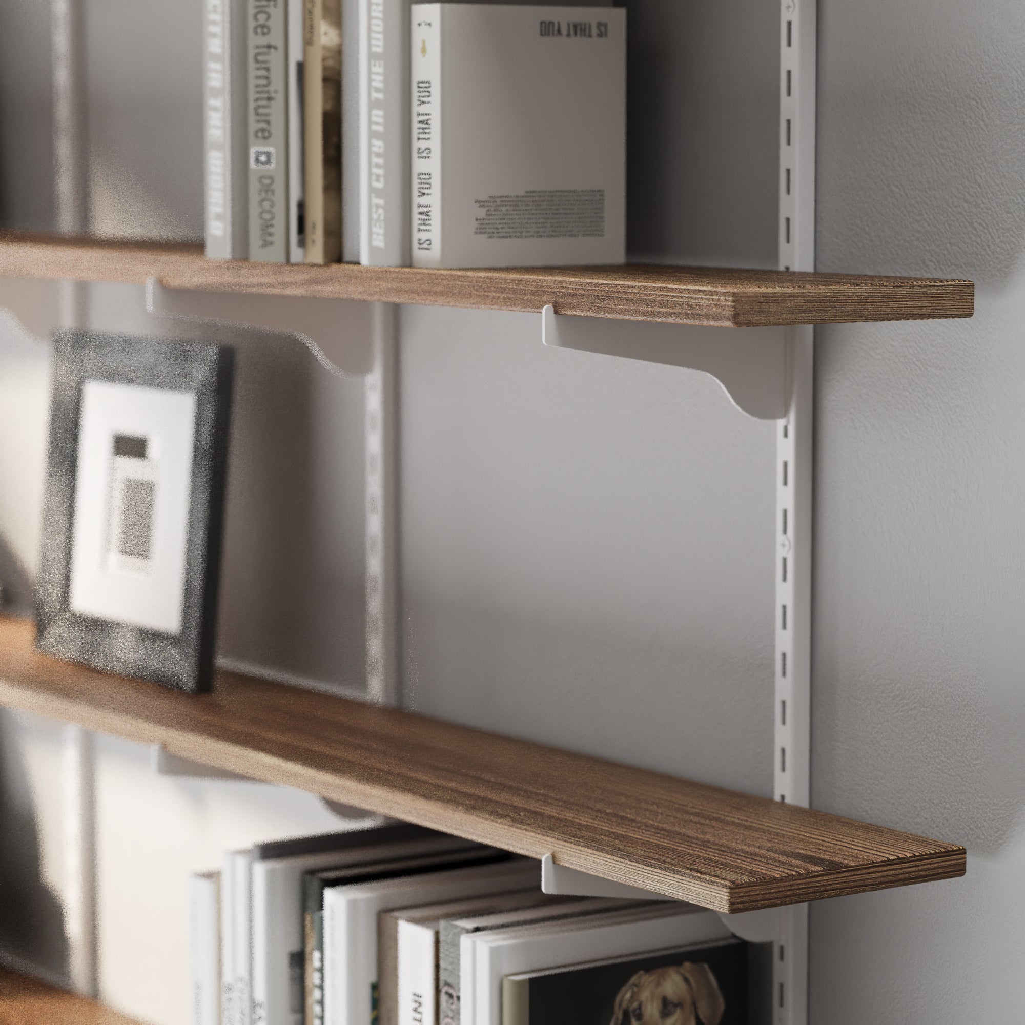 Heavy duty bracket shelf with books and a picture frame against a gray wall