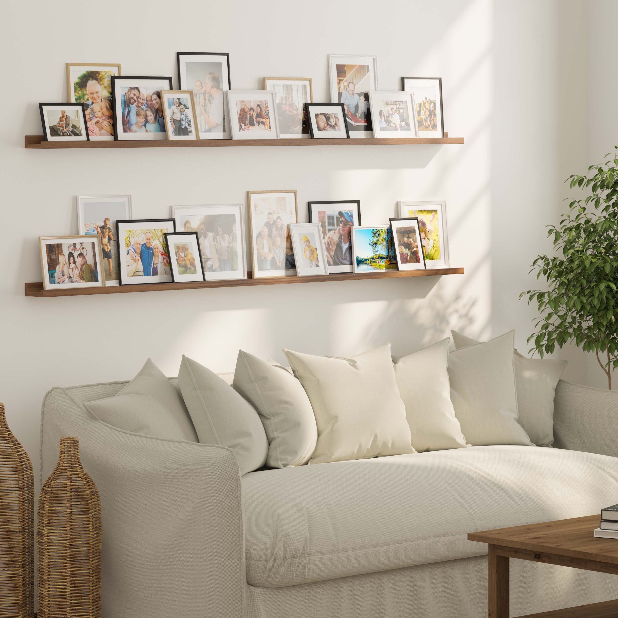 A cozy living space with a neutral-toned sofa adorned with plush cushions. Two picture frame shelves with ledge above display an assortment of framed family photos. Natural light streams in, enhancing the warm and inviting ambiance.