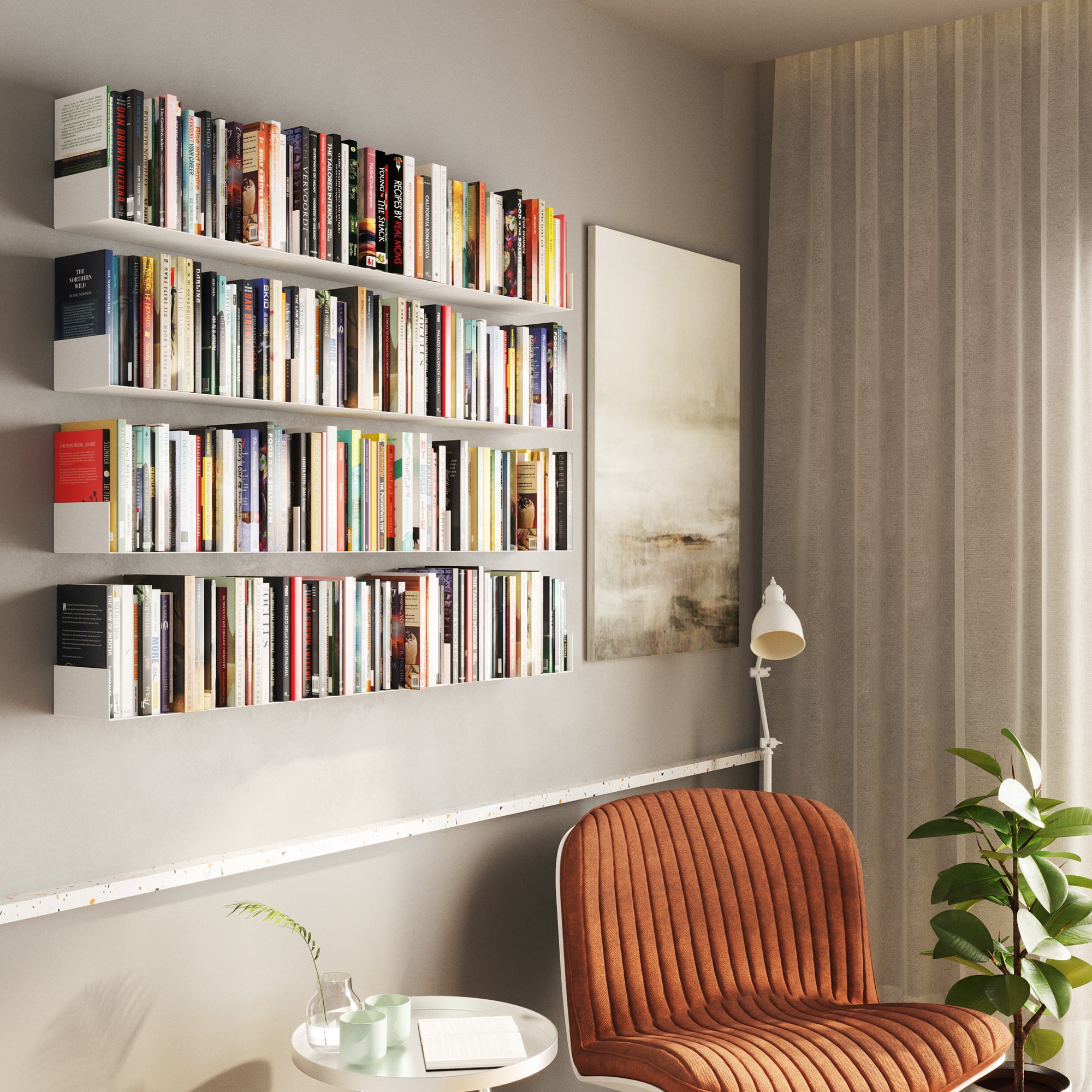 A cozy reading nook featuring white floating shelves densely packed with books, an art piece, and an orange chair, creating an inviting library-style corner.