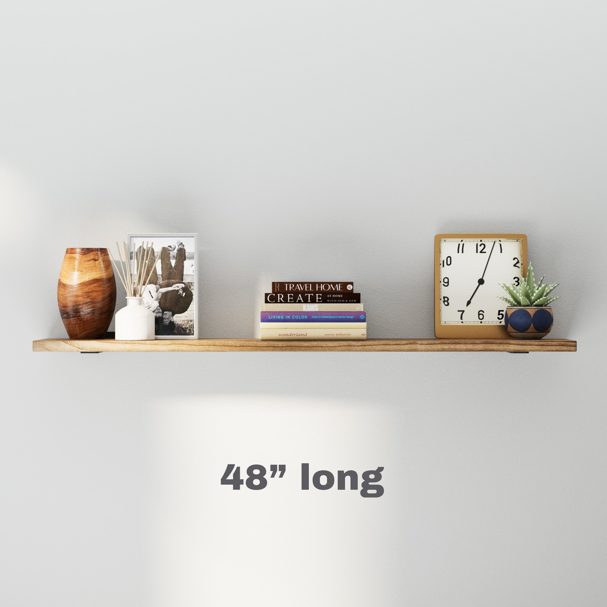 a minimalistic 48 inch wooden shelf with decor elements like books, a clock, and a small plant, perfect for compact spaces or accent walls.