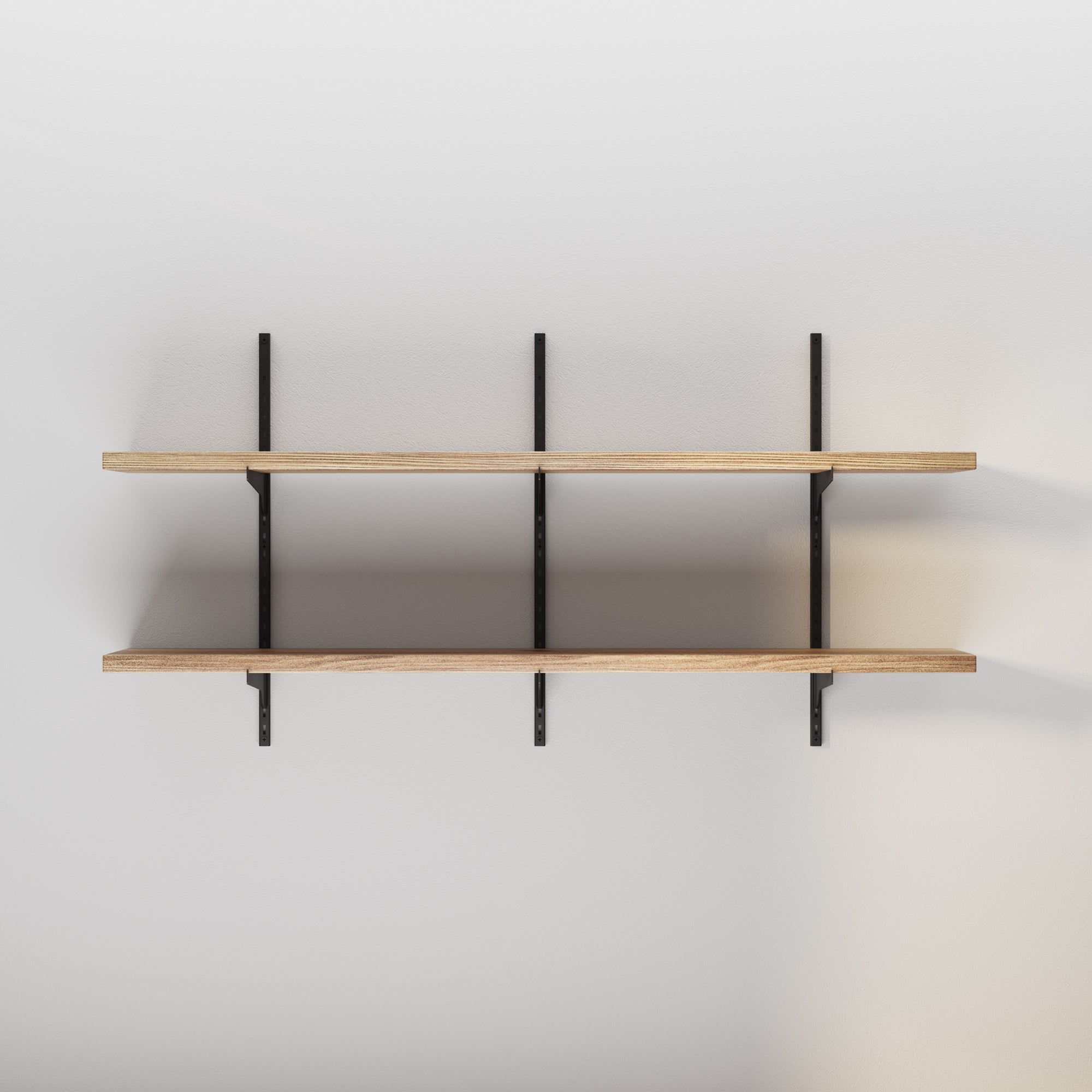 A shelving unit for shelf decor aesthetic mounted on a wall with black metal brackets, empty and ready to hold items.