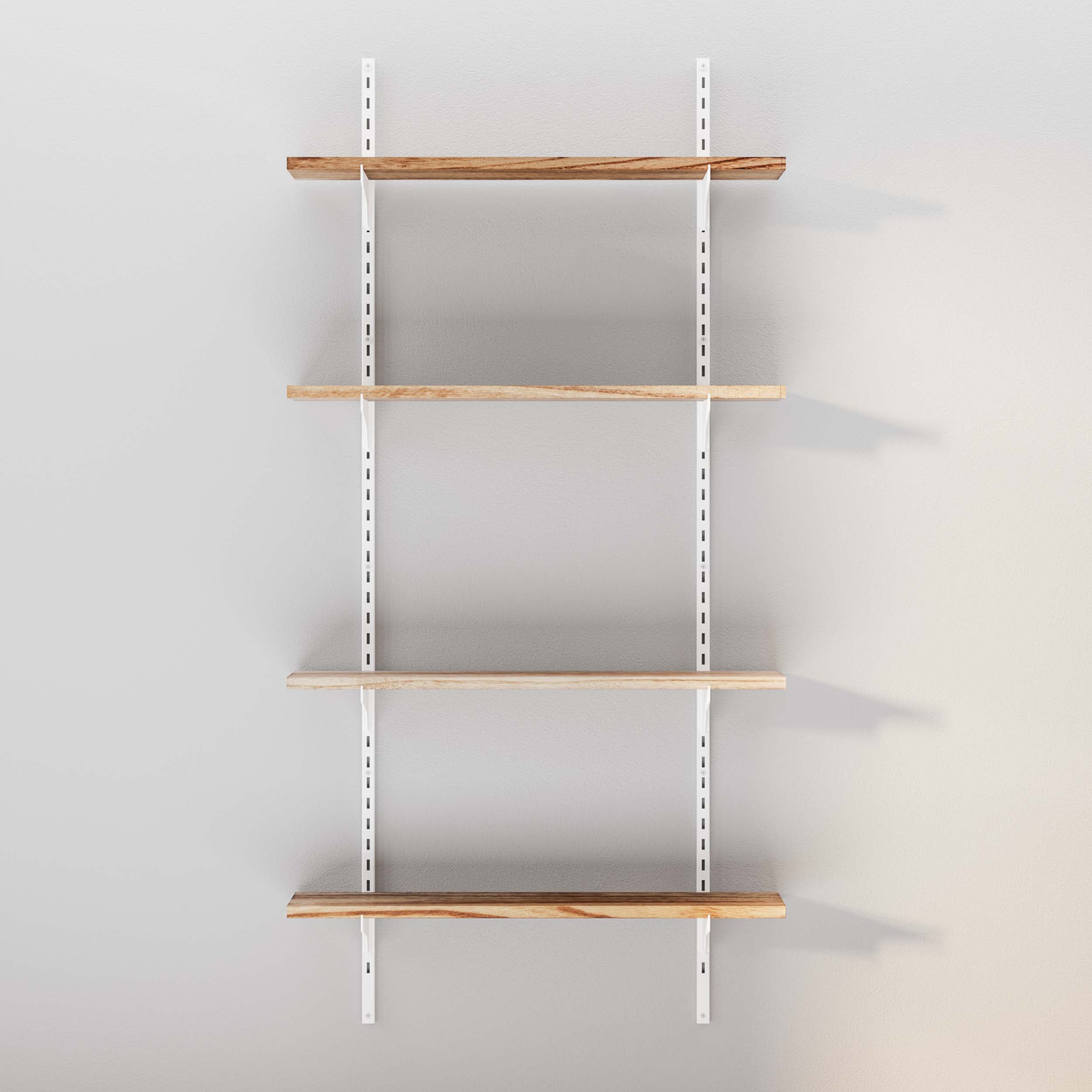 Empty wooden shelves with white brackets against a grey wall.