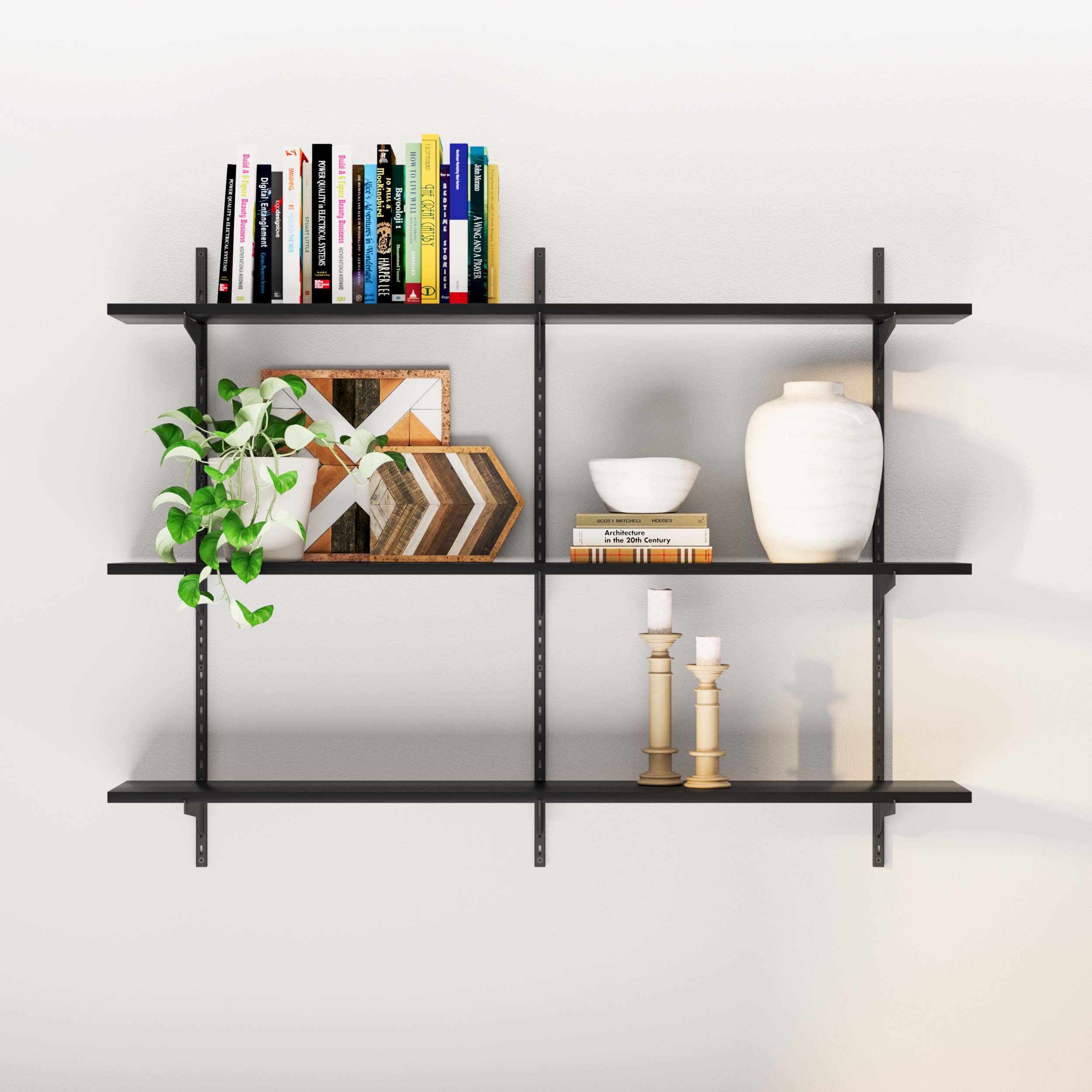 Display shelves black with books, frames, plant, and ceramic décor in a living space.