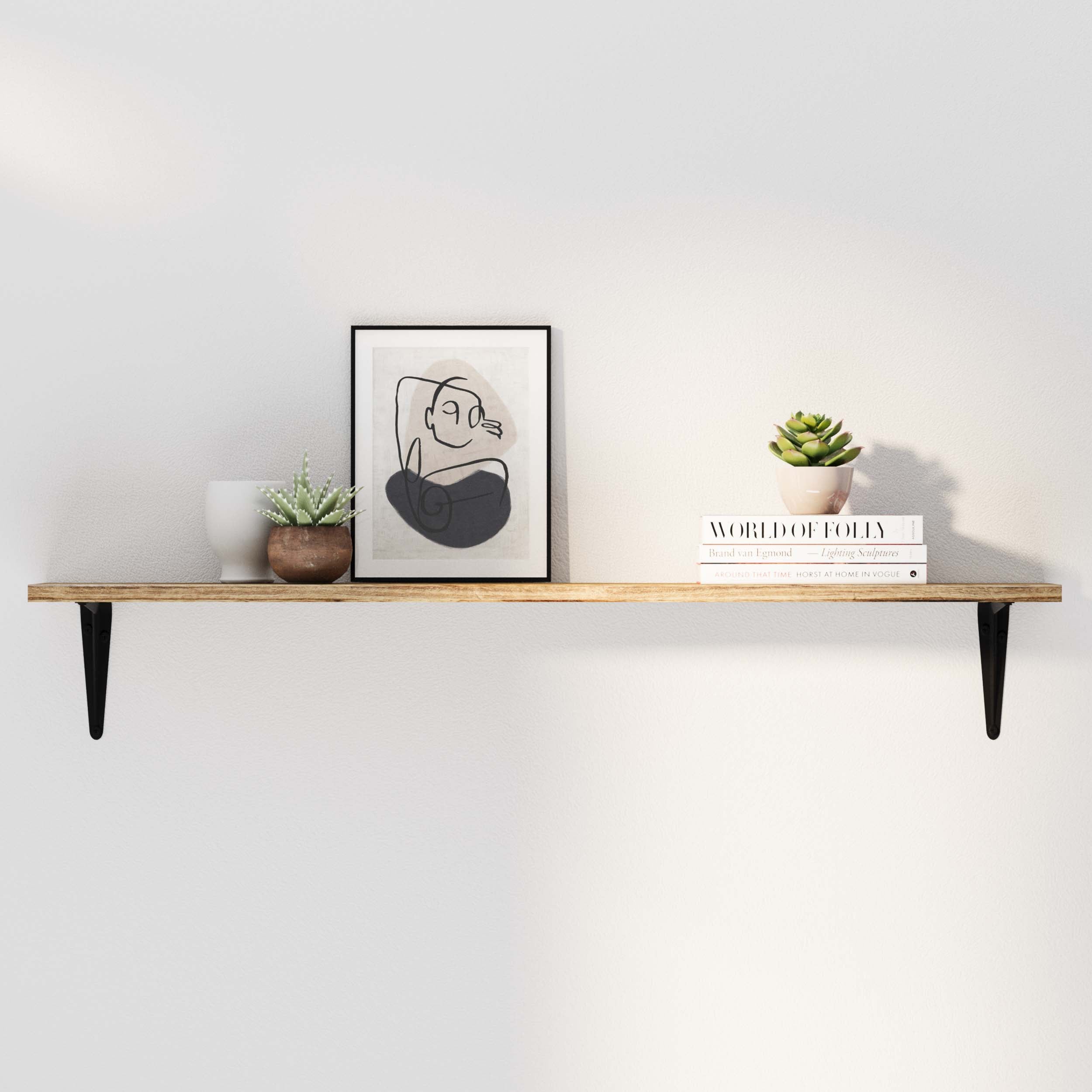 Hanging shelf burnt color in a clean, modern setting with books, a succulent, and a framed abstract artwork.