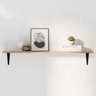 A minimalist wood wall shelf styled with a modern abstract frame, a white vase, and small succulents. Clean and elegant wall decor with functional storage.