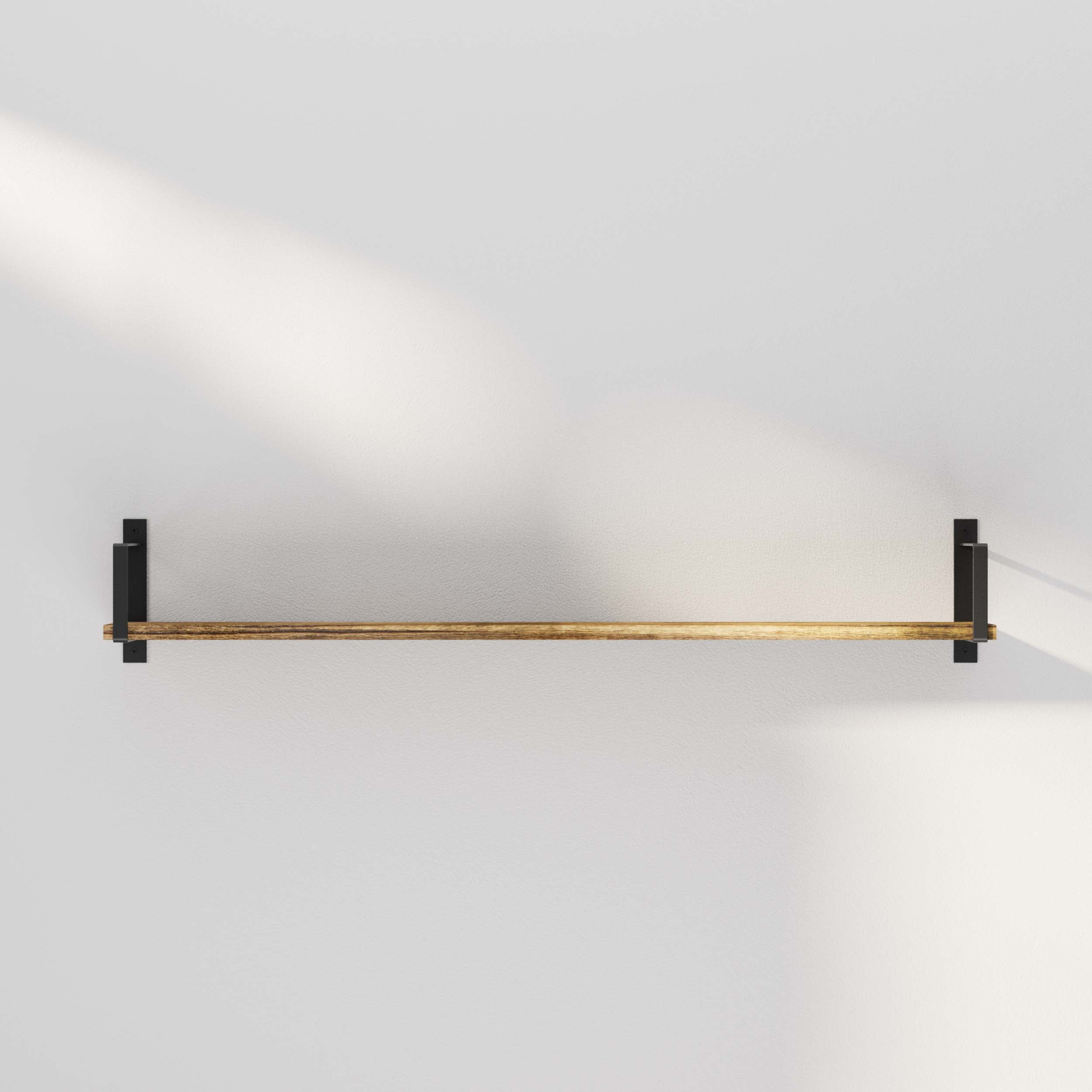Empty wooden shelf mounted on a wall with soft light casting a diagonal shadow, emphasizing minimalism.