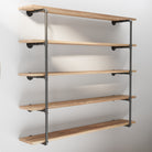 A close-up of empty pipe floating shelf unit, highlighting the sturdy iron pipe brackets and the clean, minimalist design of the burnt wood shelves. Perfect for modern and industrial decor styles.