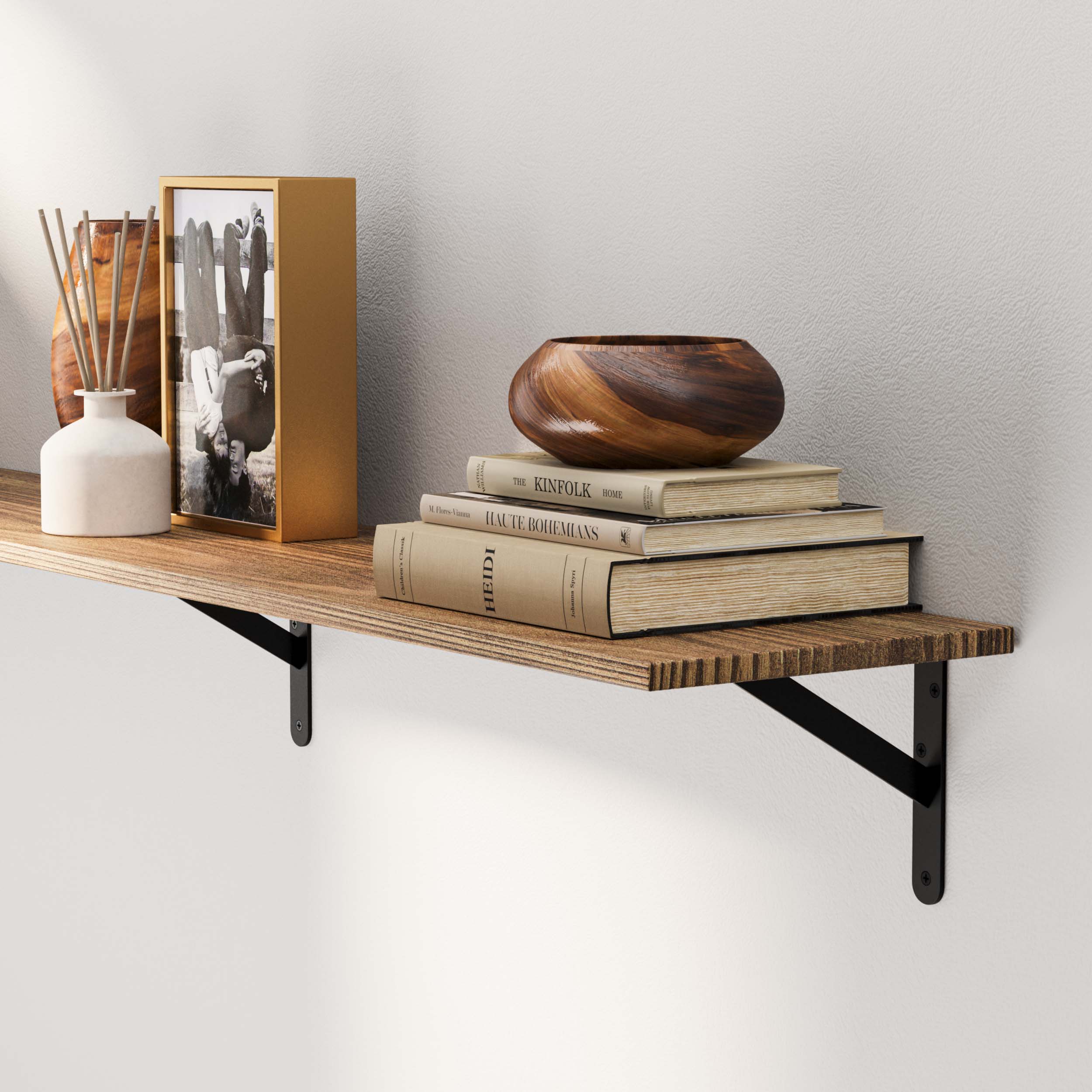 Wood shelf showcasing the wooden texture, black brackets, and stylish decor items like books, a vase, and a picture frame. A natural and warm feel to the shelf setup.