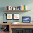 An office storage shelf burnt color over a desk featuring books, stationery, and framed motivational art, perfect for a home office or study nook