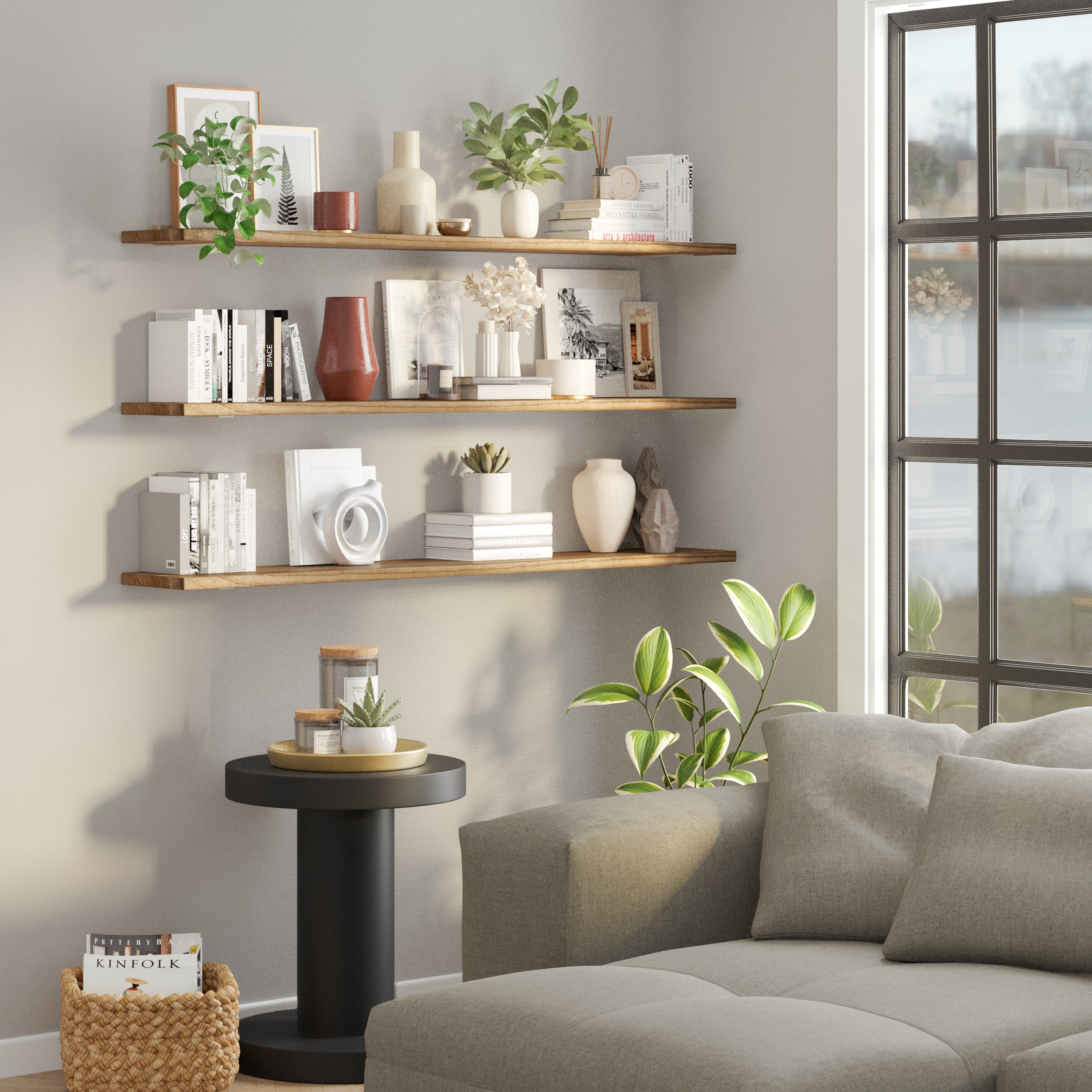 A cozy corner with three living room shelves for wall styled with plants, decor, and books, perfect for creating a relaxing and chic reading nook.