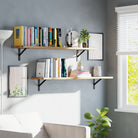 Two book shelves for living room decor adorned with books, potted plants, and frames. Positioned above a couch, offering a cozy and decorative addition to the living room storage solution.