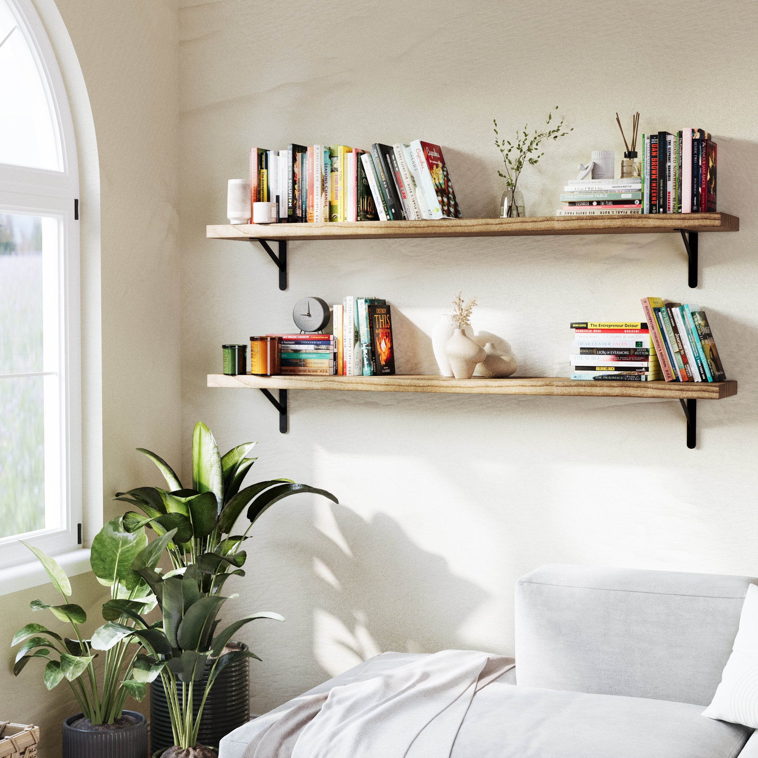 Bedroom corner with two bedroom shelves wall mounted, styled with books and decor items. Positioned above a cozy bed, it integrates nature-inspired accents and sunlight streaming through an arched window.