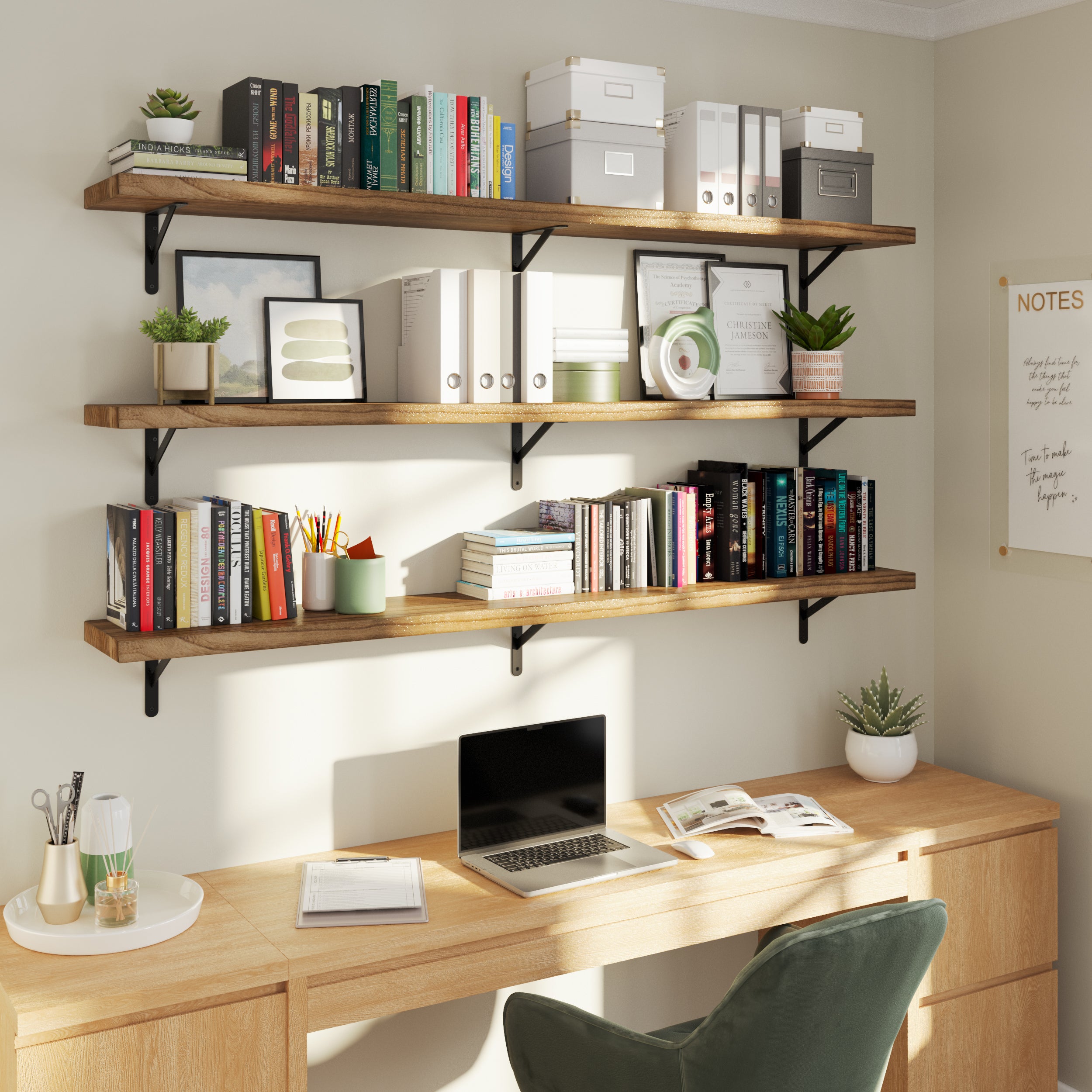 A workspace setup with three wooden shelves holding books, organizers, and decor, combining practicality and aesthetic appeal for an inspiring home office.