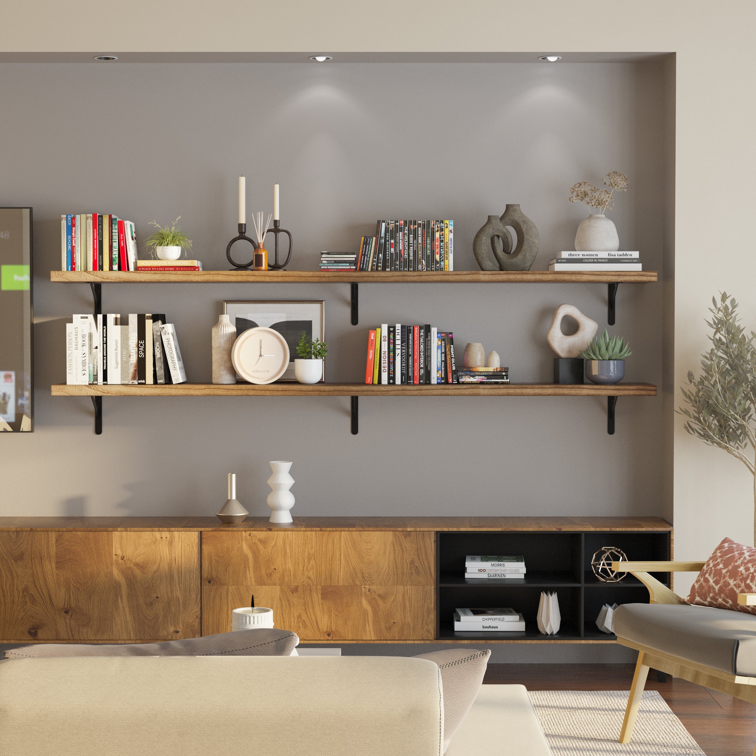 A modern living room setup featuring two rustic wall book shelves mounted on a gray wall, elegantly styled with books, plants, and decorative objects.