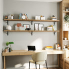 A home office featuring two office shelves with rich burnt finish mounted above a wooden desk, filled with office essentials, books, and decorative elements for a practical yet stylish workspace.