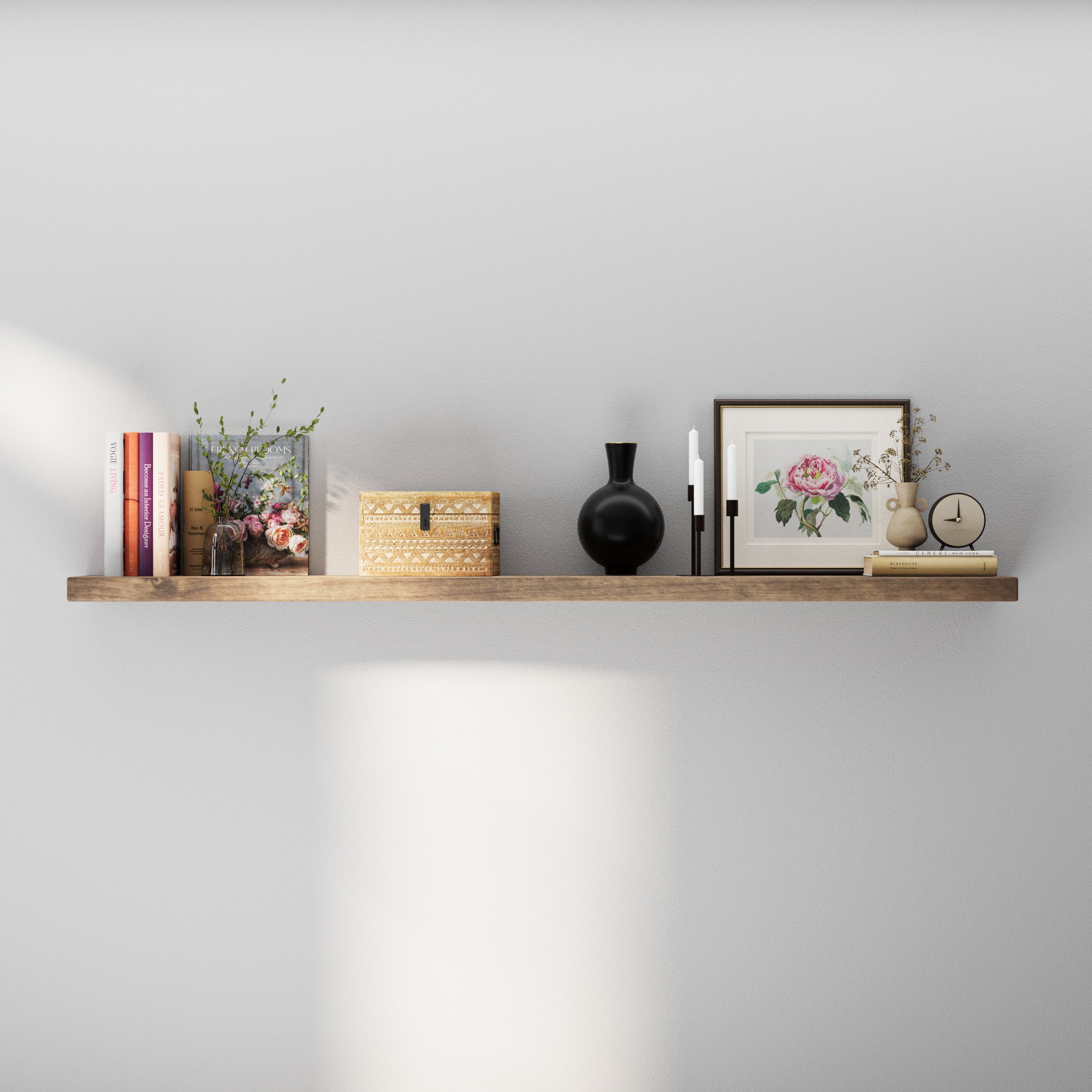 A single floating shelf styled with neutral-toned books, a decorative box, a black vase, and minimalist decor, perfect for a calm, sophisticated look.