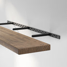 Hidden bracket mechanism shows the sturdy metal support system used to achieve a clean, modern floating shelf design.