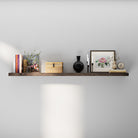 A 60 inch long hidden bracket shelf with books, a decorative vase, a black sculpture, and a floral framed print—styled in a soft, neutral-toned setting that highlights modern elegance.