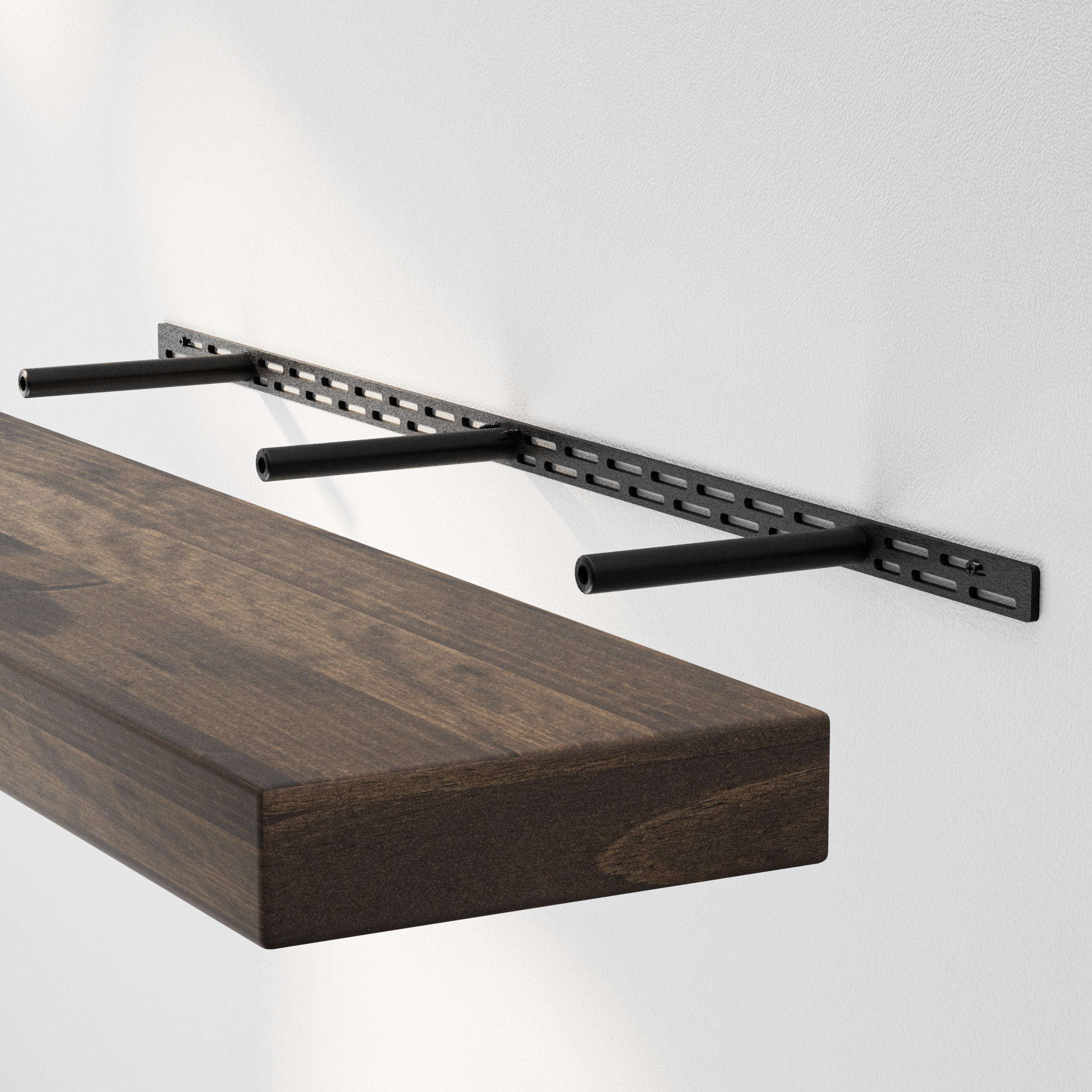 A floating shelf installation shows the sturdy hidden bracket system supporting a thick espresso-finished wood board, highlighting its durable structure.