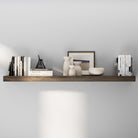 A single dark wooden floating shelf 60 inch long displays minimalist décor with neutral-toned vases, books, and framed art, offering a calm and refined modern aesthetic.