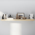 A single long floating shelf in a natural wood finish styled with ceramic vases, neutral-toned books, and framed wall art, offering a minimalist and airy decorative look.