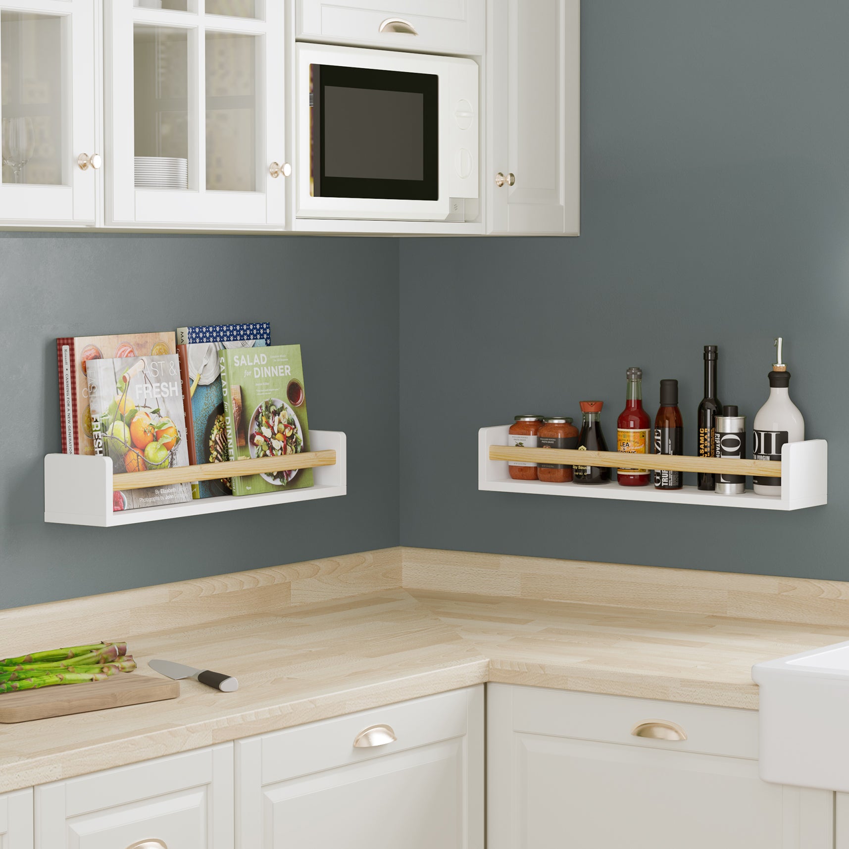 Two white wall shelves for kitchen with natural wood rods in a kitchen setting, holding cookbooks and condiments. Mounted on a dark gray wall above a light wood countertop, providing practical and stylish storage.