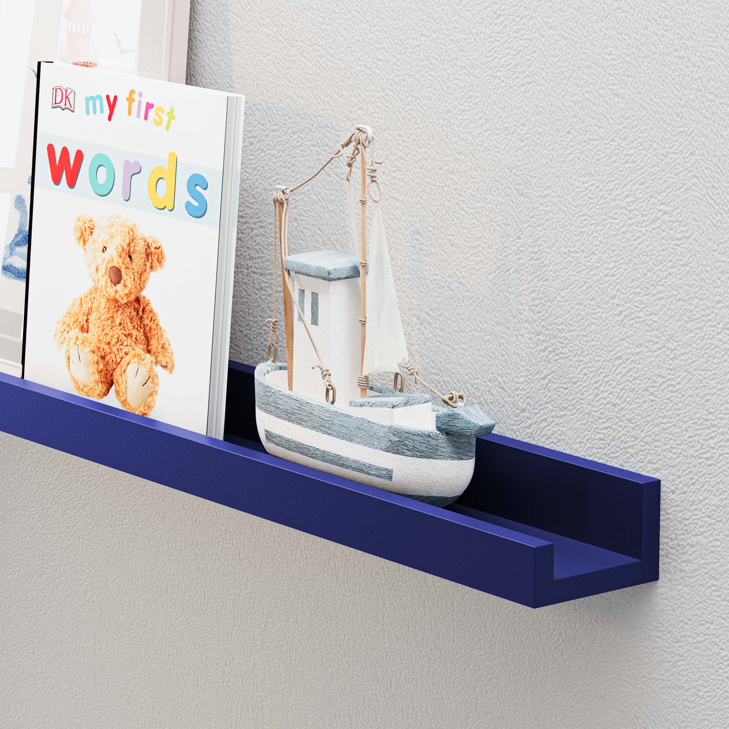 navy blue shelf in use, featuring items such as a children's book titled "My First Words" and a small model boat. The scene emphasizes the shelf's ability to serve as both a functional storage solution and a decorative element, particularly in a child’s room or a space with a nautical theme.